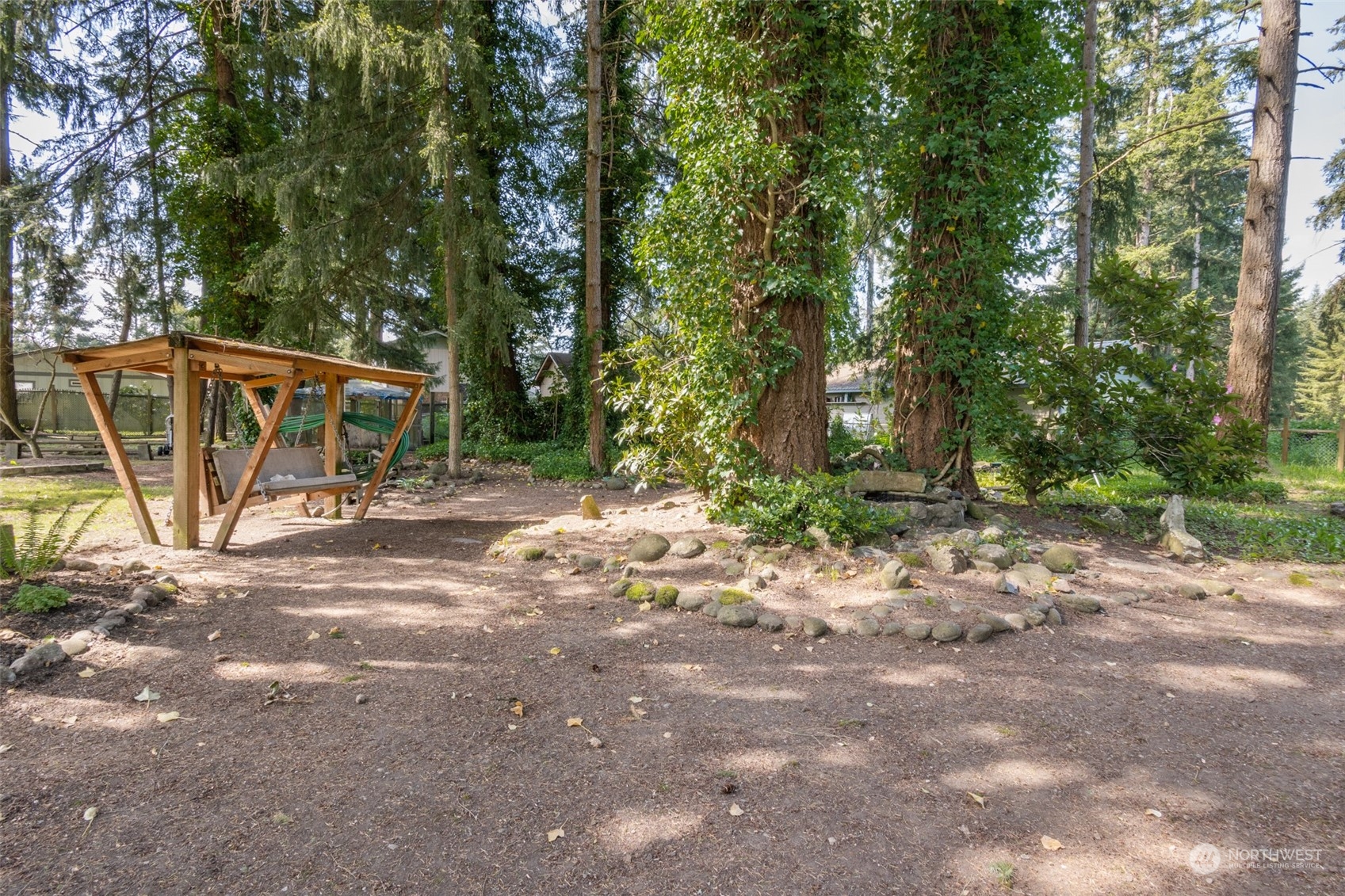 8117 176th Avenue Southwest Rochester, WA 98579 - Photo 27 of 27 a view of a wooden house with a tree