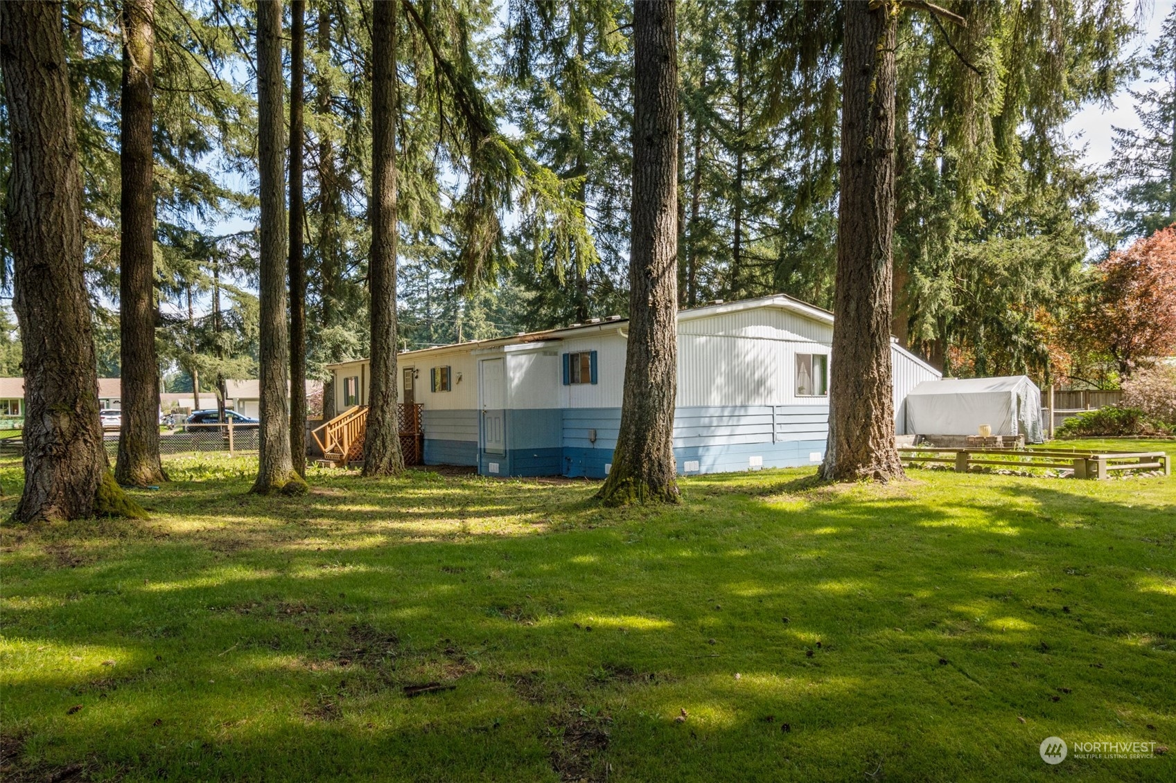 8117 176th Avenue Southwest Rochester, WA 98579 - Photo 7 of 27 a view of a house with a big yard and large trees