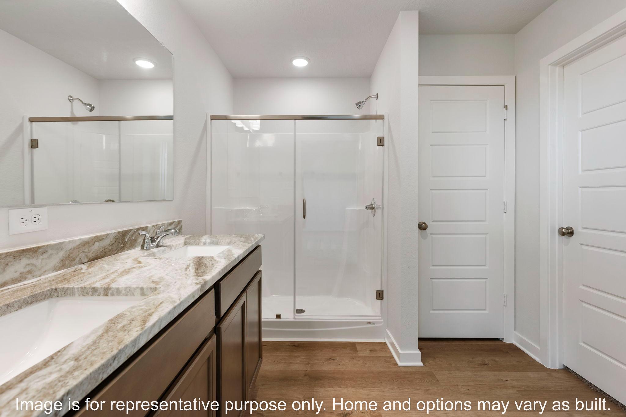 228 Gus Loop Georgetown, TX 78626 - Photo 14 of 16 a bathroom with a granite countertop sink a mirror and a shower
