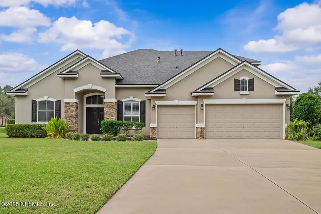 a front view of a house with a yard and garage