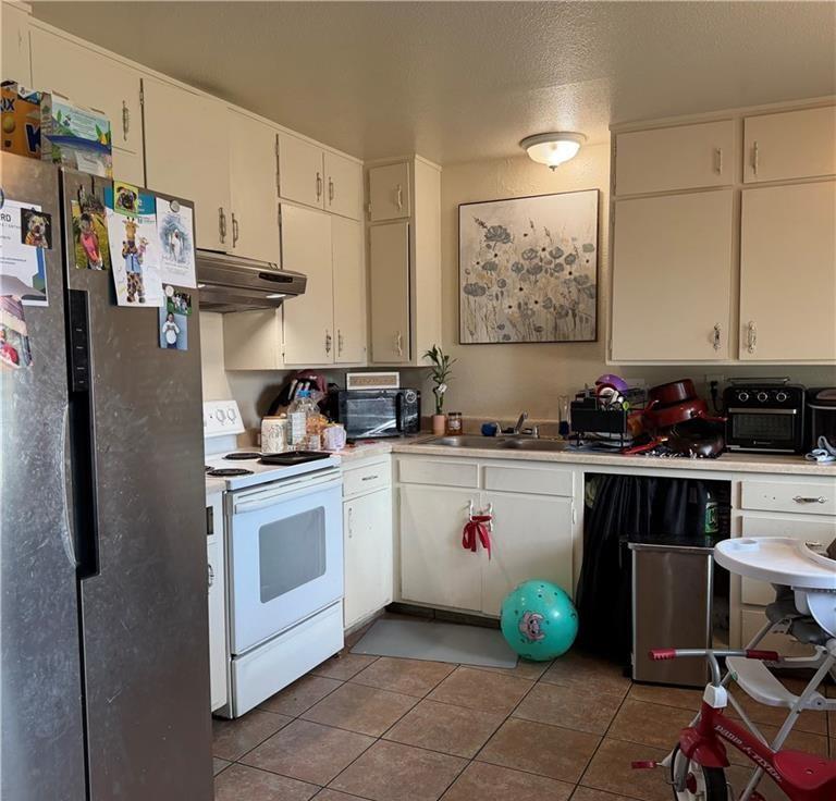1567 Ellen Court Merced, CA 95341 - Photo 16 of 16 a kitchen with a sink cabinets and appliances