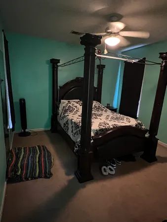 a bed sitting in a bedroom next to a window