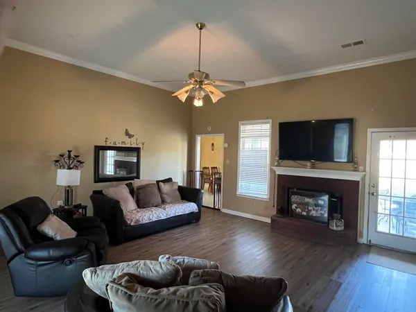 a living room with furniture a fireplace and a flat screen tv