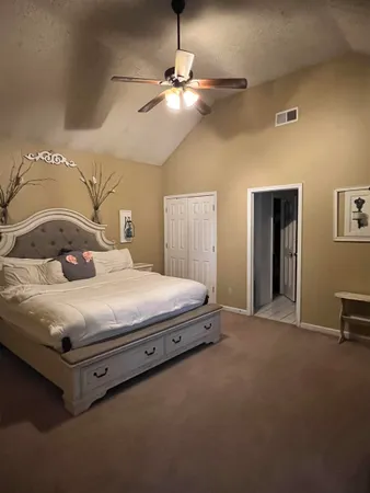 a bedroom with a bed and a chandelier