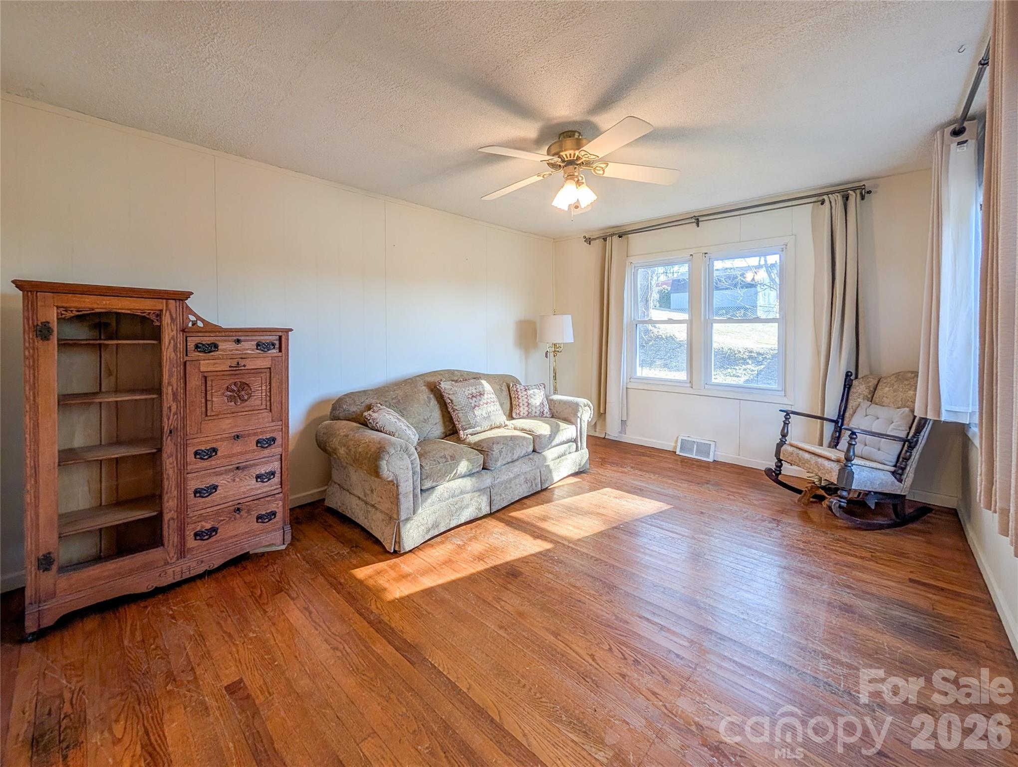 97 Tom Sparks Road Spruce Pine, NC 28777 - Photo 12 of 35 a living room with furniture and a wooden floor