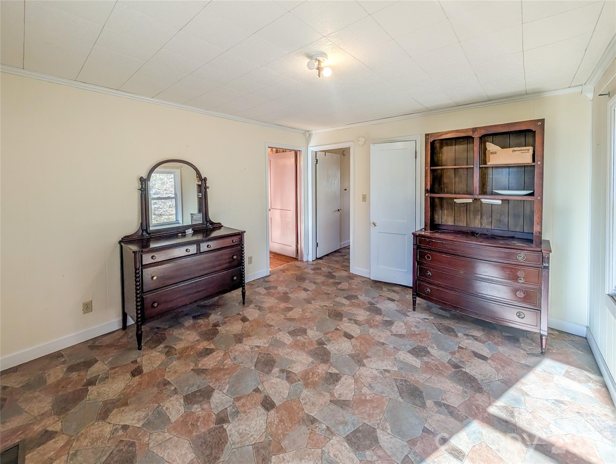 97 Tom Sparks Road Spruce Pine, NC 28777 - Photo 17 of 35 a spacious bedroom with a bed and a dresser