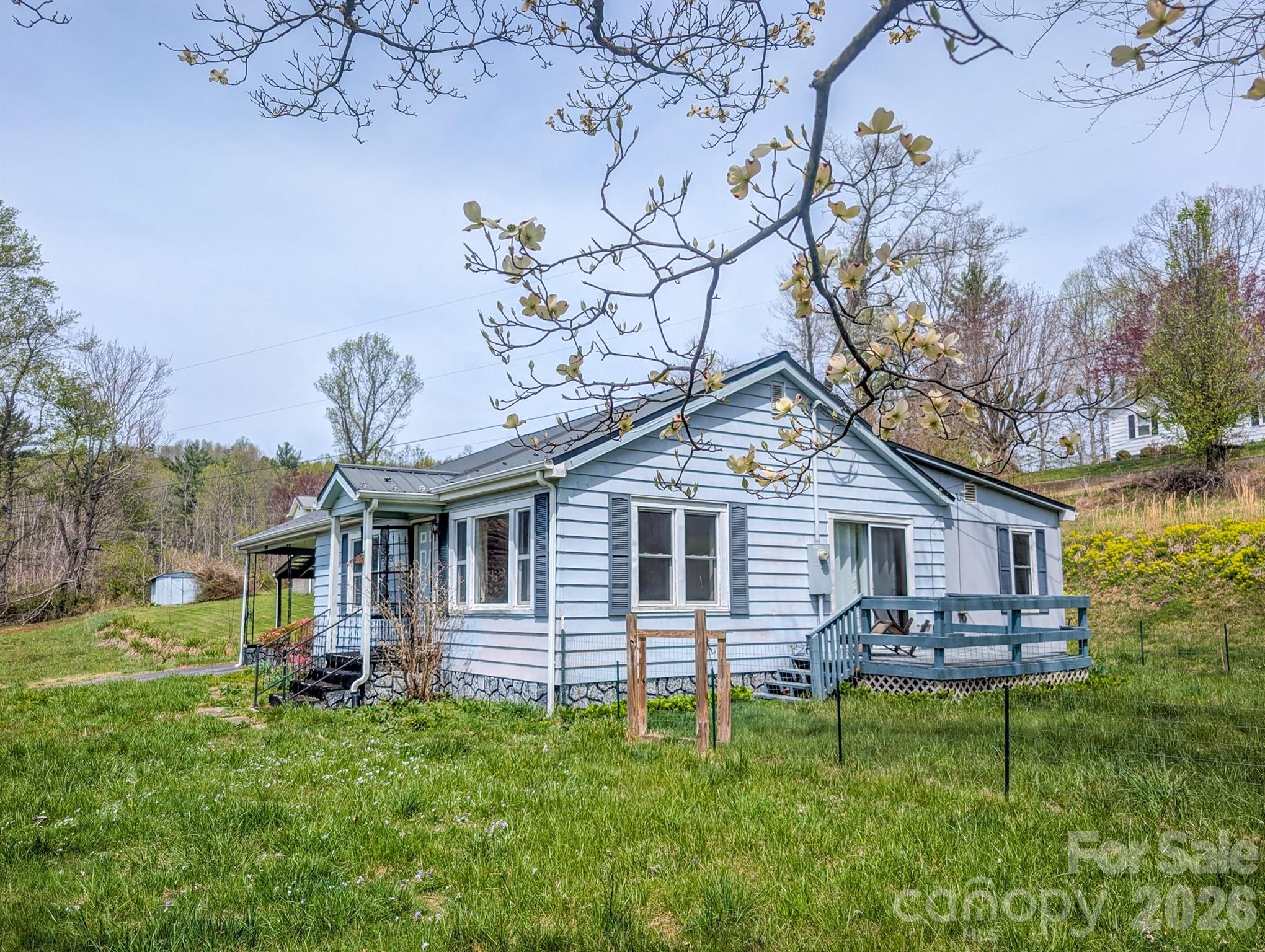97 Tom Sparks Road Spruce Pine, NC 28777 - Photo 25 of 35 a view of a house with a backyard and a patio