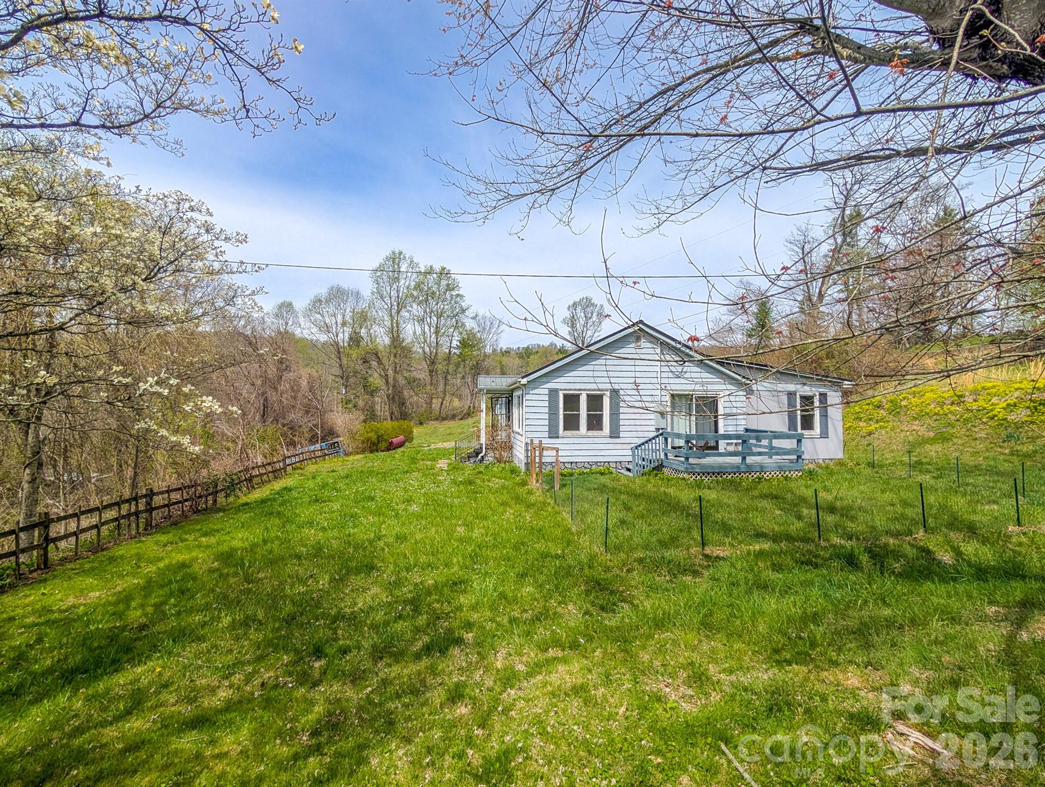 97 Tom Sparks Road Spruce Pine, NC 28777 - Photo 26 of 35 a house view with a garden space