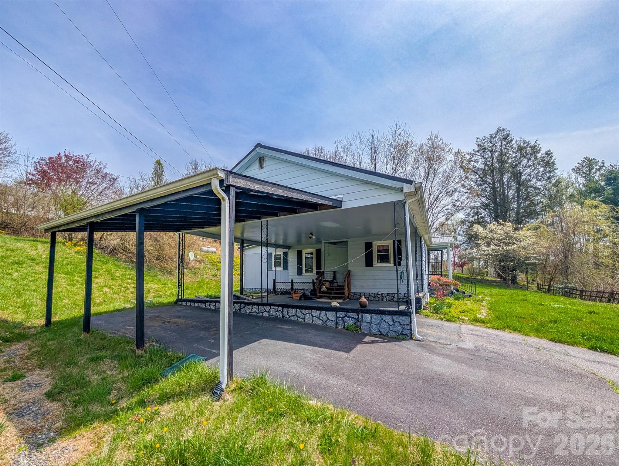 97 Tom Sparks Road Spruce Pine, NC 28777 - Photo 27 of 35 a view of a chair and table in backyard of the house