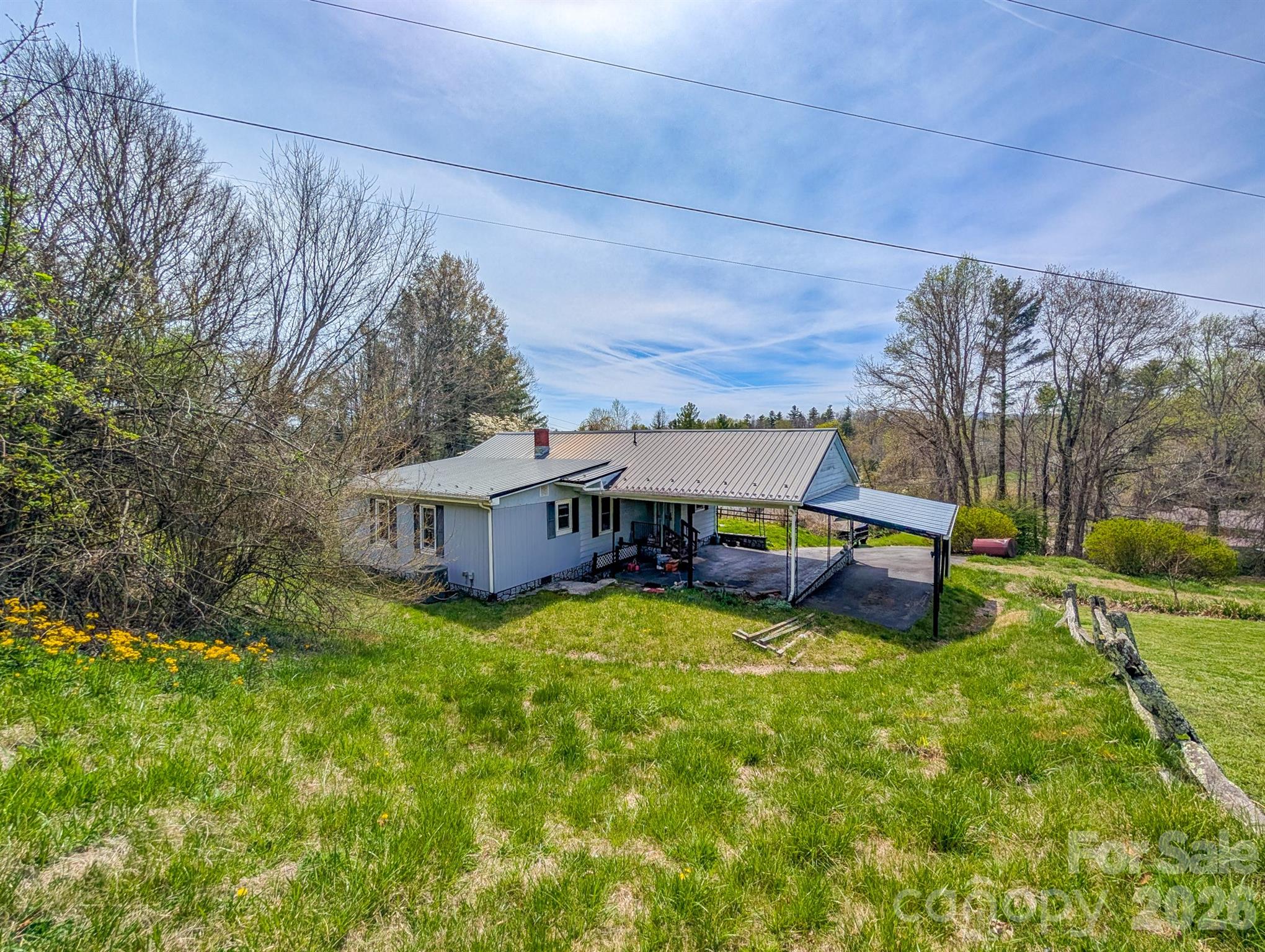 97 Tom Sparks Road Spruce Pine, NC 28777 - Photo 33 of 35 a view of a house with a big yard and large trees