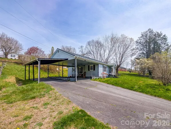 a view of a dining room with furniture a chandelier and wooden floor