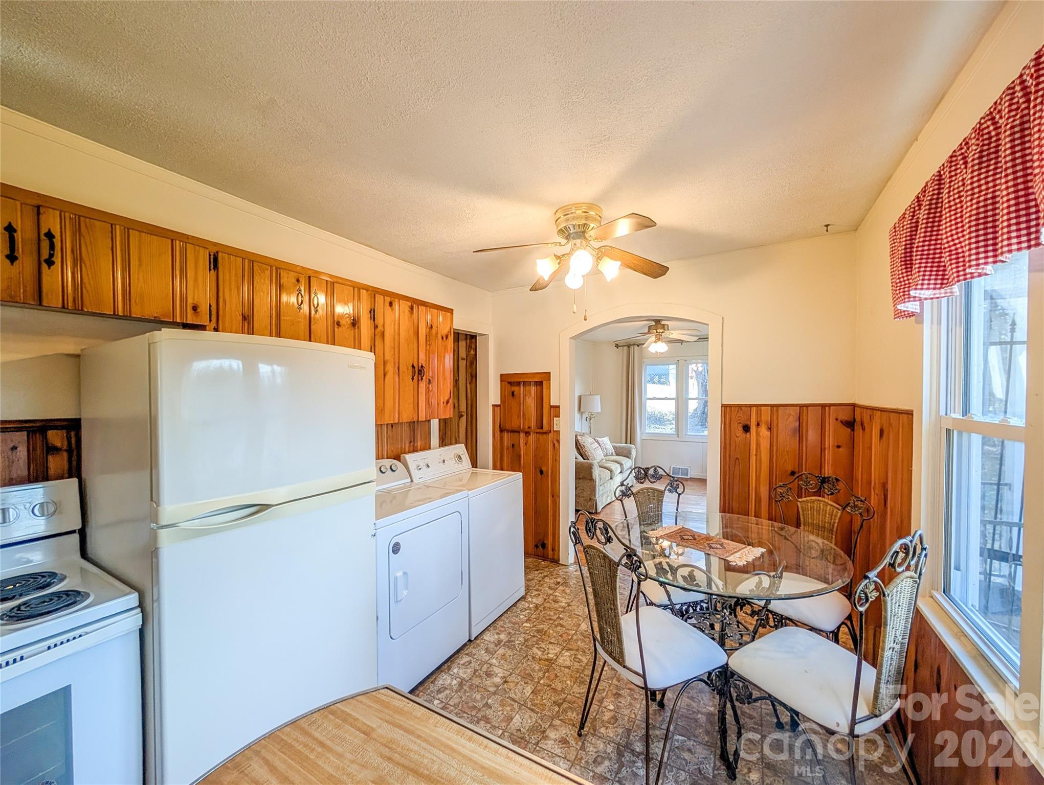 97 Tom Sparks Road Spruce Pine, NC 28777 - Photo 8 of 35 a view of a dining room with furniture a chandelier and wooden floor