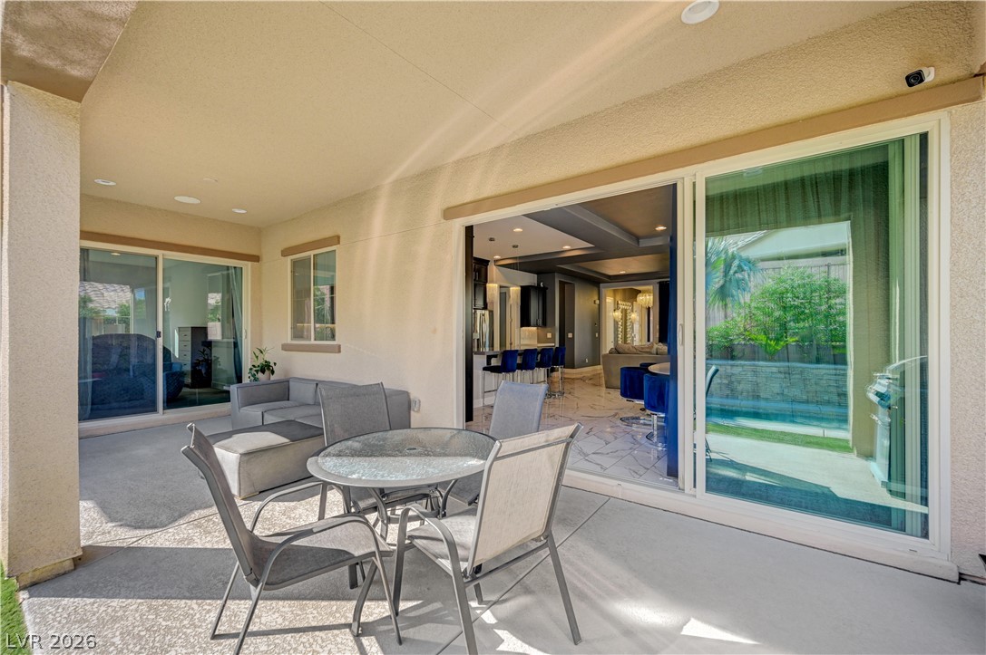 3943 Reyes Avenue Las Vegas, NV 89141 - Photo 53 of 95 An inviting outdoor living space seamlessly blends with the chic interior through expansive sliding glass doors.