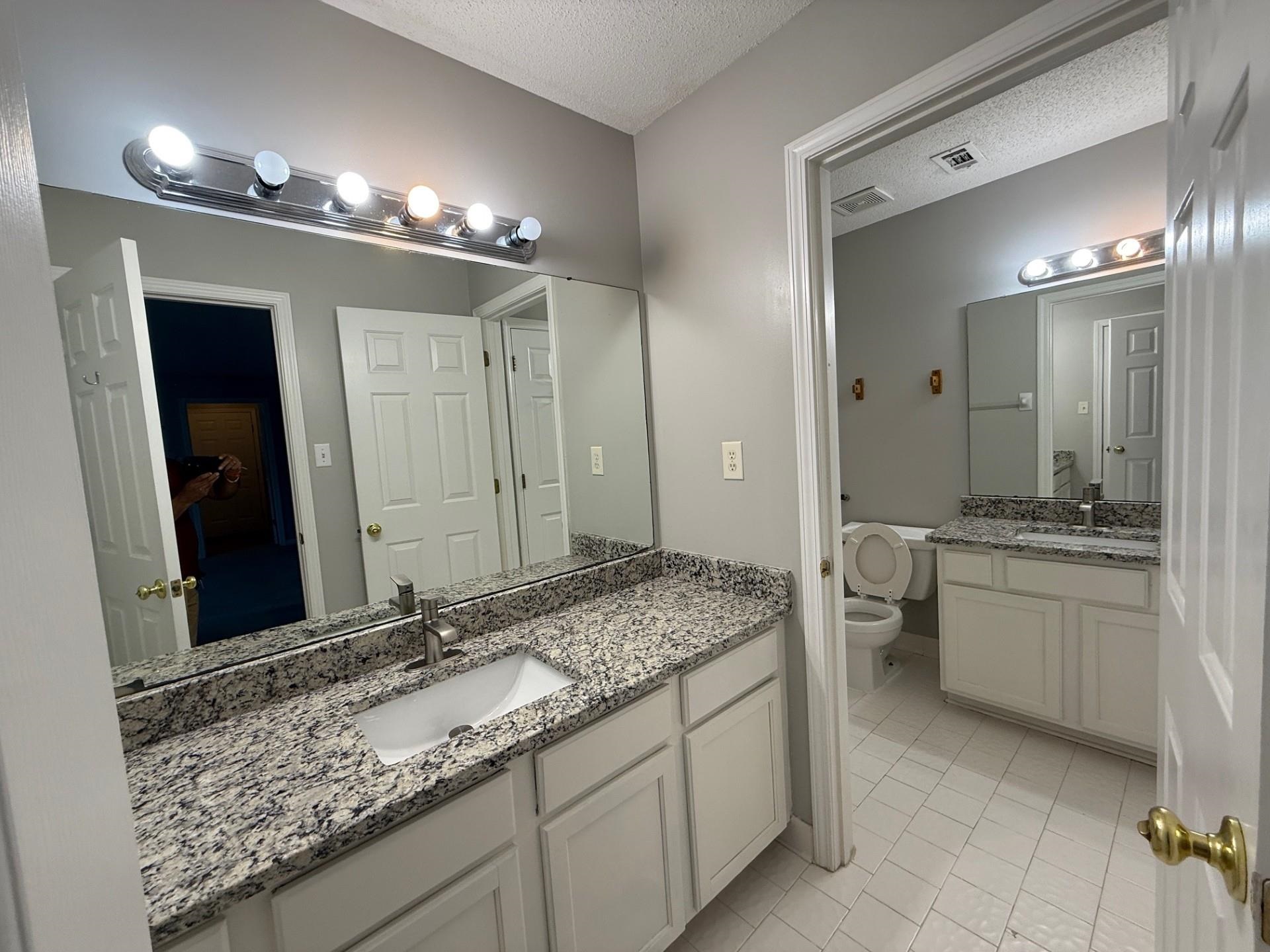 370 Lida Lane Memphis, TN 38018 - Photo 18 of 24 a bathroom with a granite countertop sink double vanity and a mirror