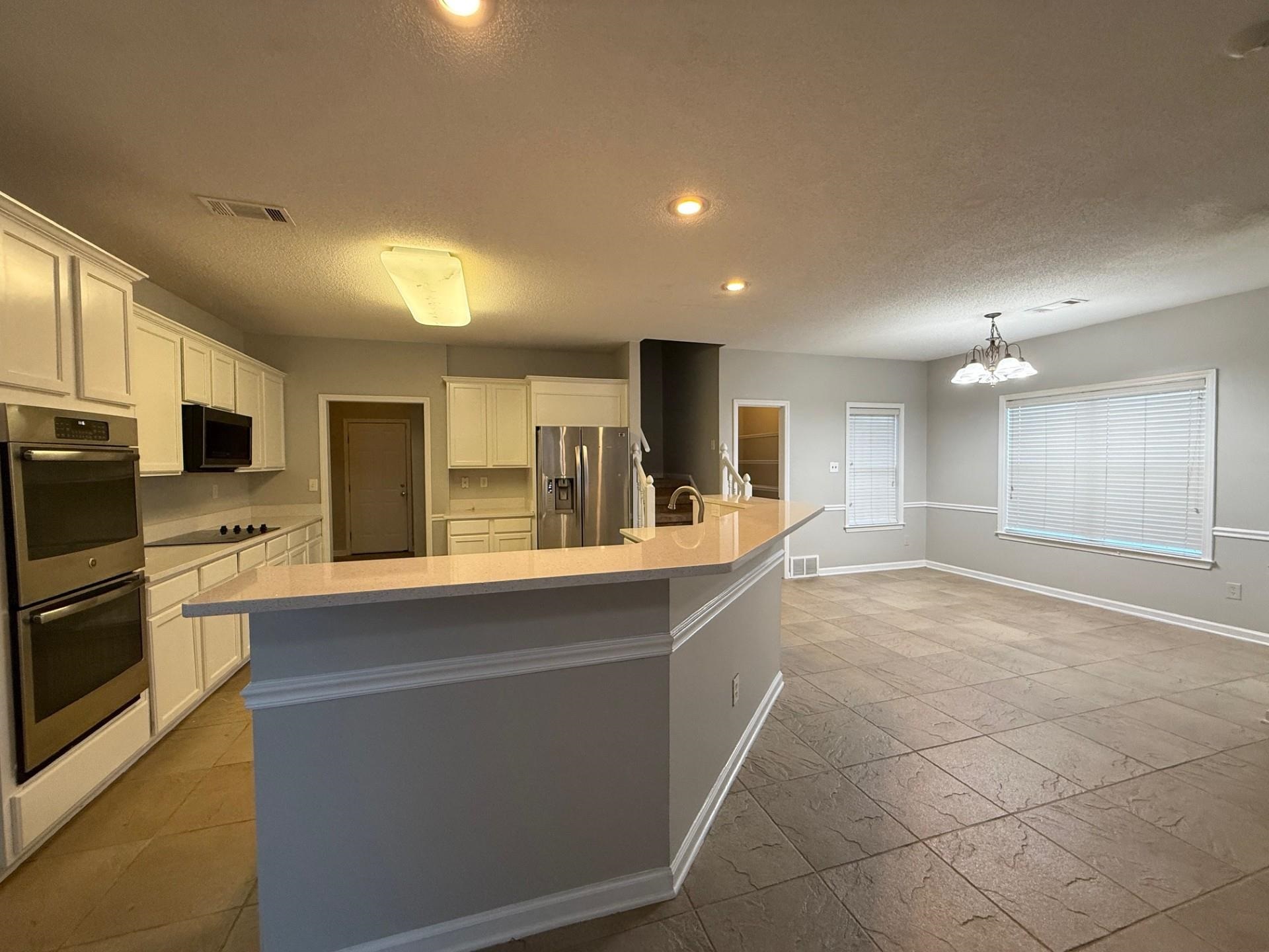 370 Lida Lane Memphis, TN 38018 - Photo 7 of 24 a large kitchen with a large counter top appliances and cabinets