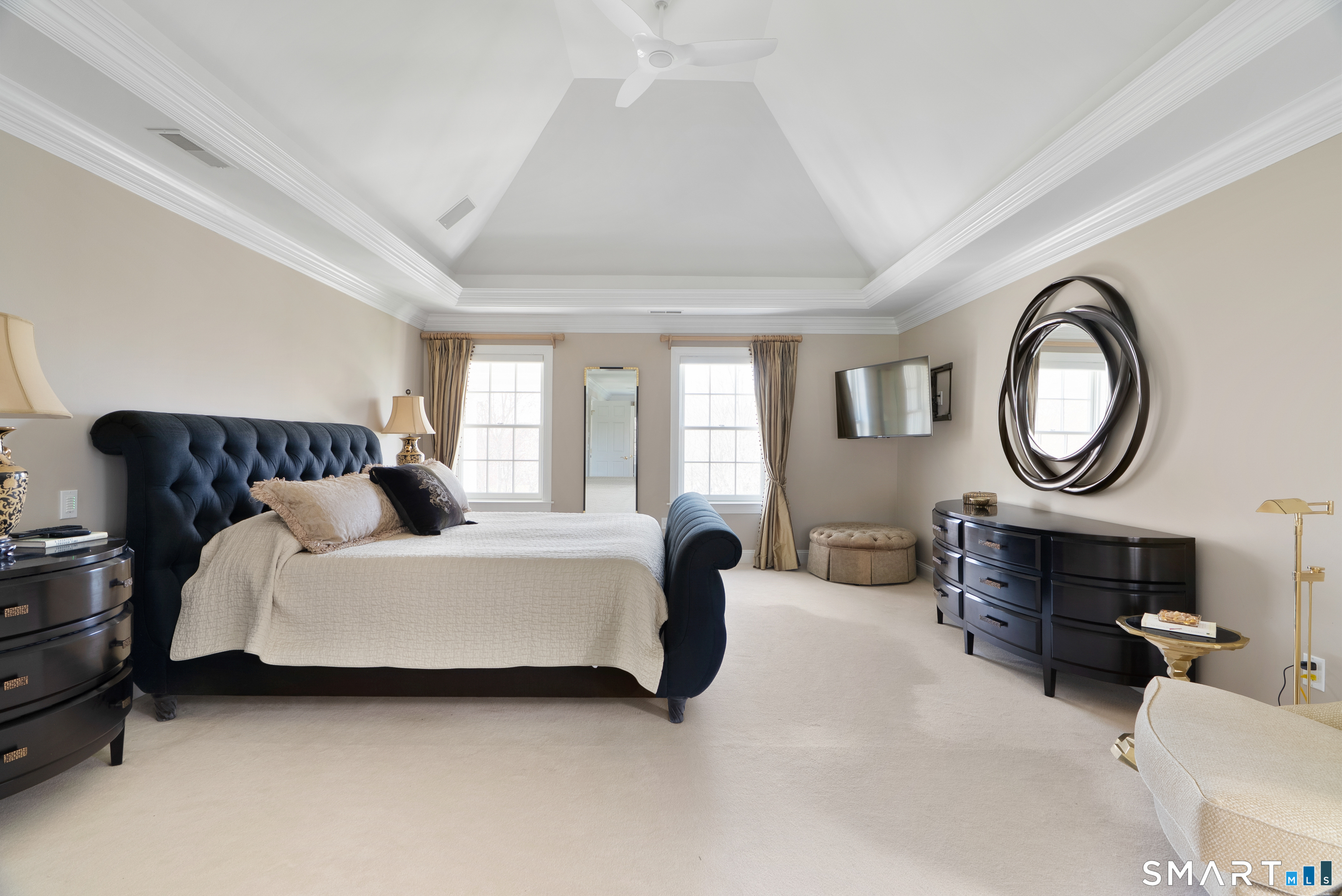 57 Thistledown Suffield, CT 06078 - Photo 18 of 39 a spacious bedroom with a bed a mirror and a chandelier