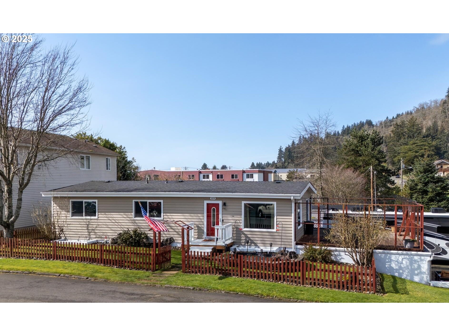 109 4th Street Garibaldi, OR 97118 - Photo 1 of 48 a view of a white house with a big yard and large trees