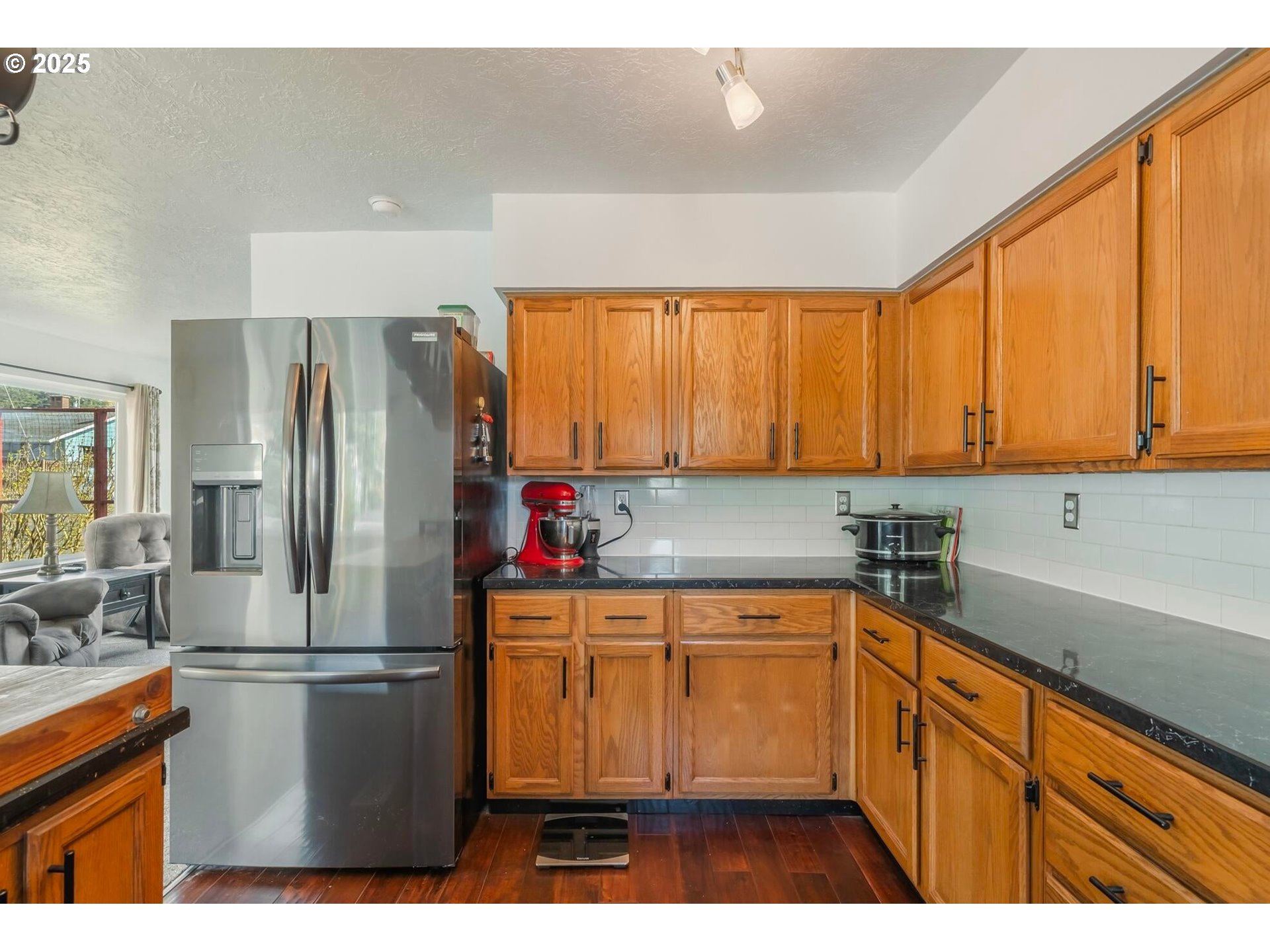109 4th Street Garibaldi, OR 97118 - Photo 11 of 48 a kitchen with stainless steel appliances a refrigerator sink and cabinets