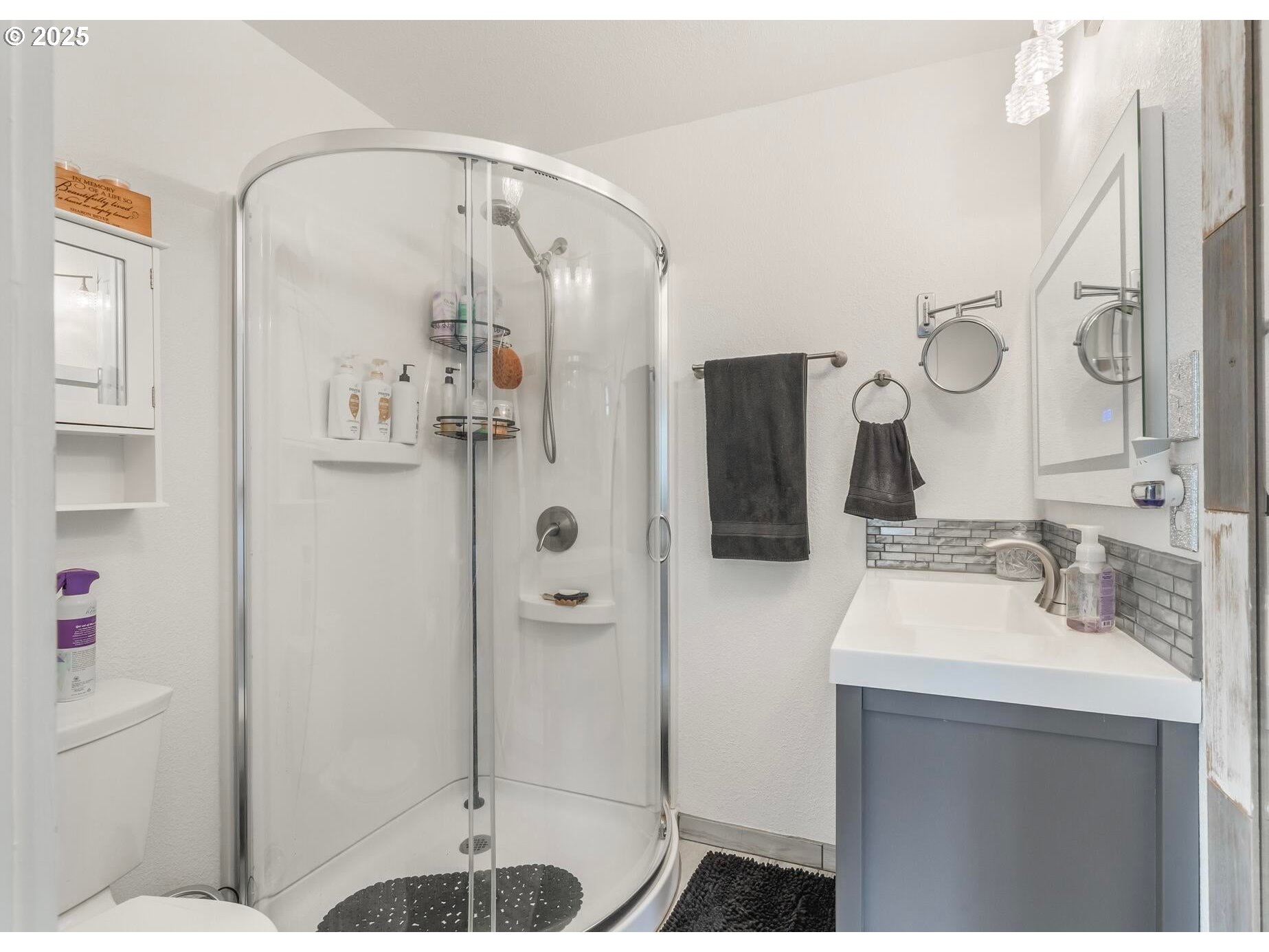 109 4th Street Garibaldi, OR 97118 - Photo 16 of 48 a bathroom with a sink vanity granite shower and glass door