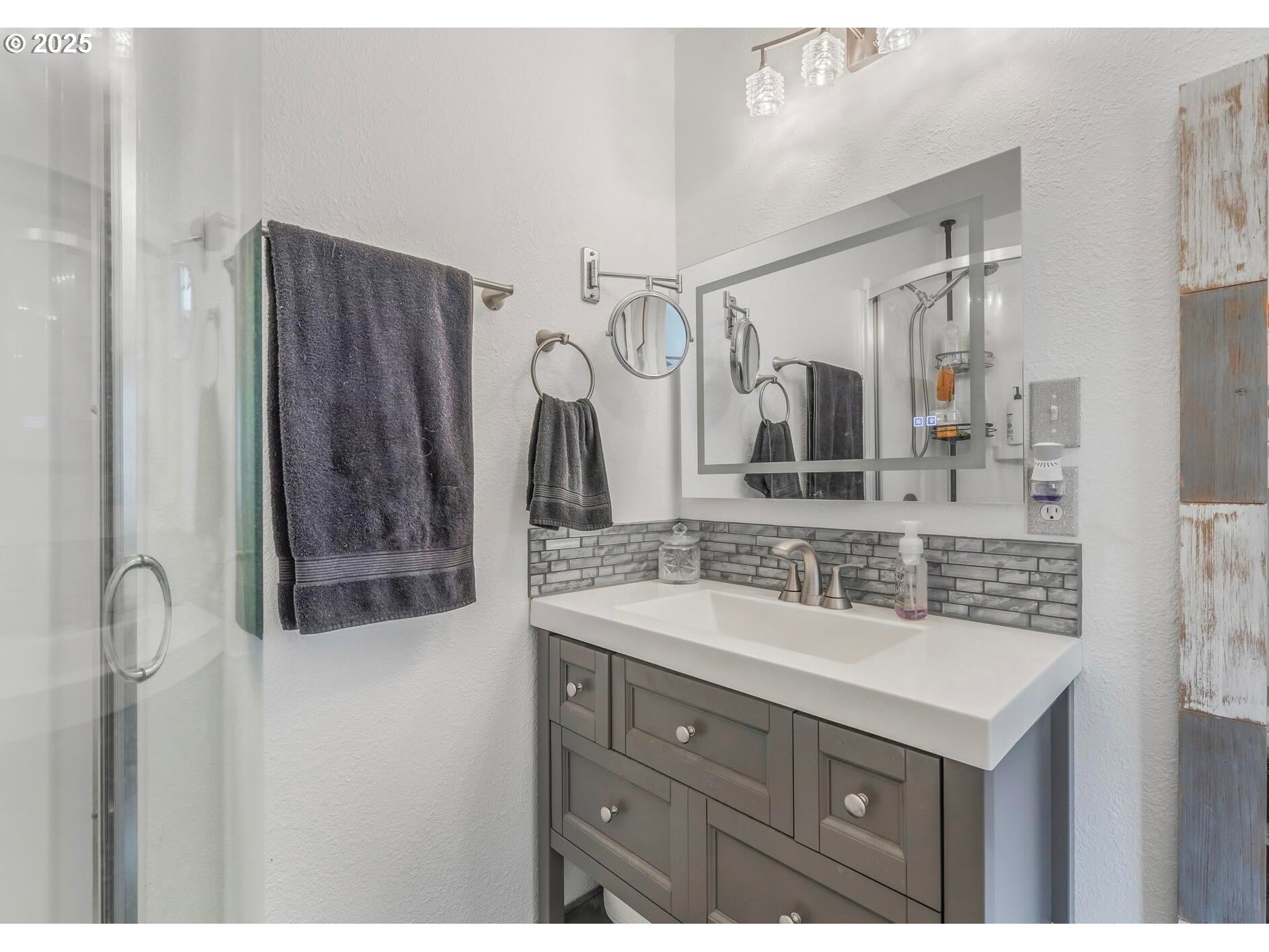 109 4th Street Garibaldi, OR 97118 - Photo 17 of 48 a bathroom with a sink vanity granite tub shower and a mirror
