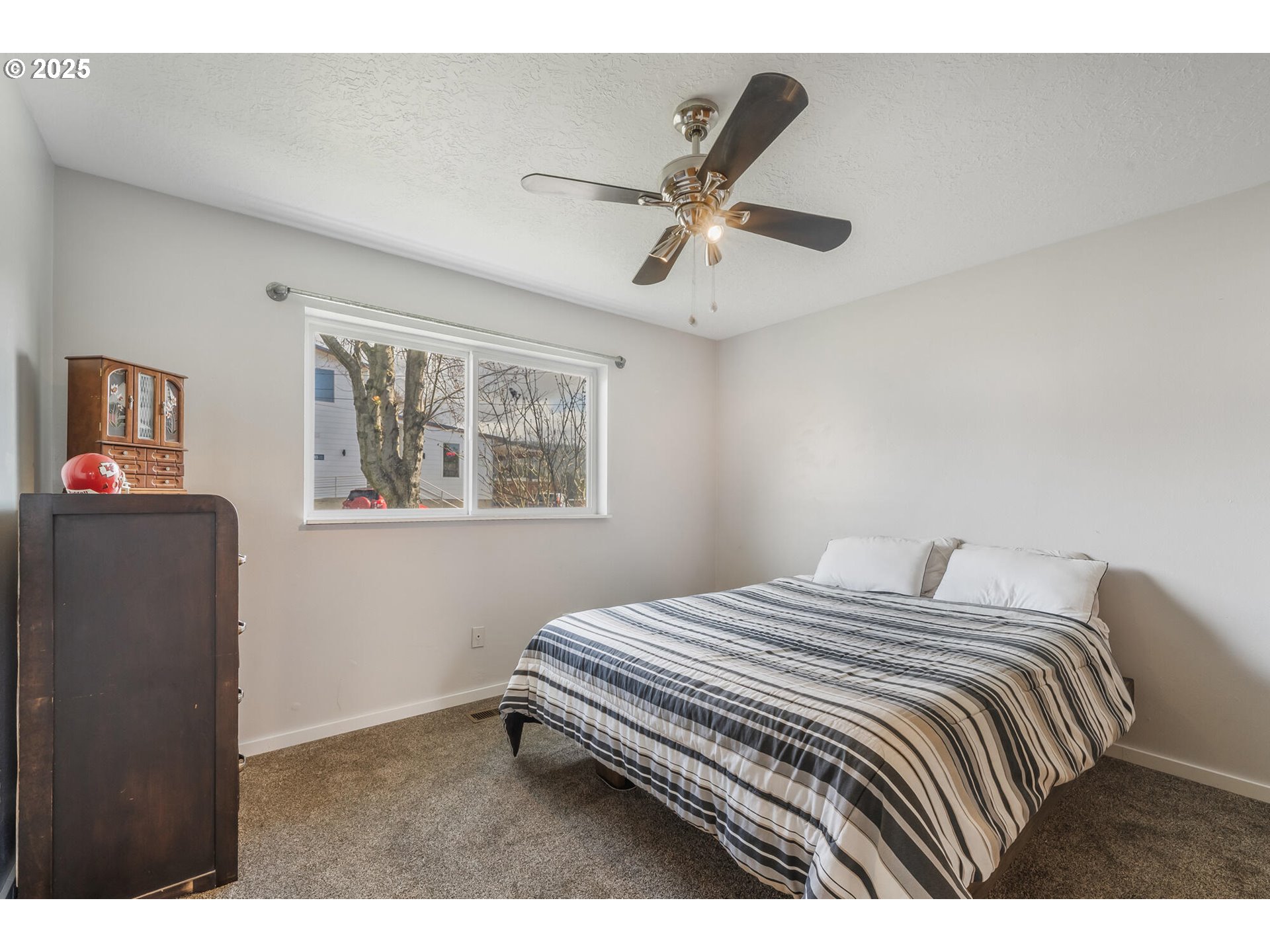 109 4th Street Garibaldi, OR 97118 - Photo 18 of 48 a bedroom with a bed and a chandelier