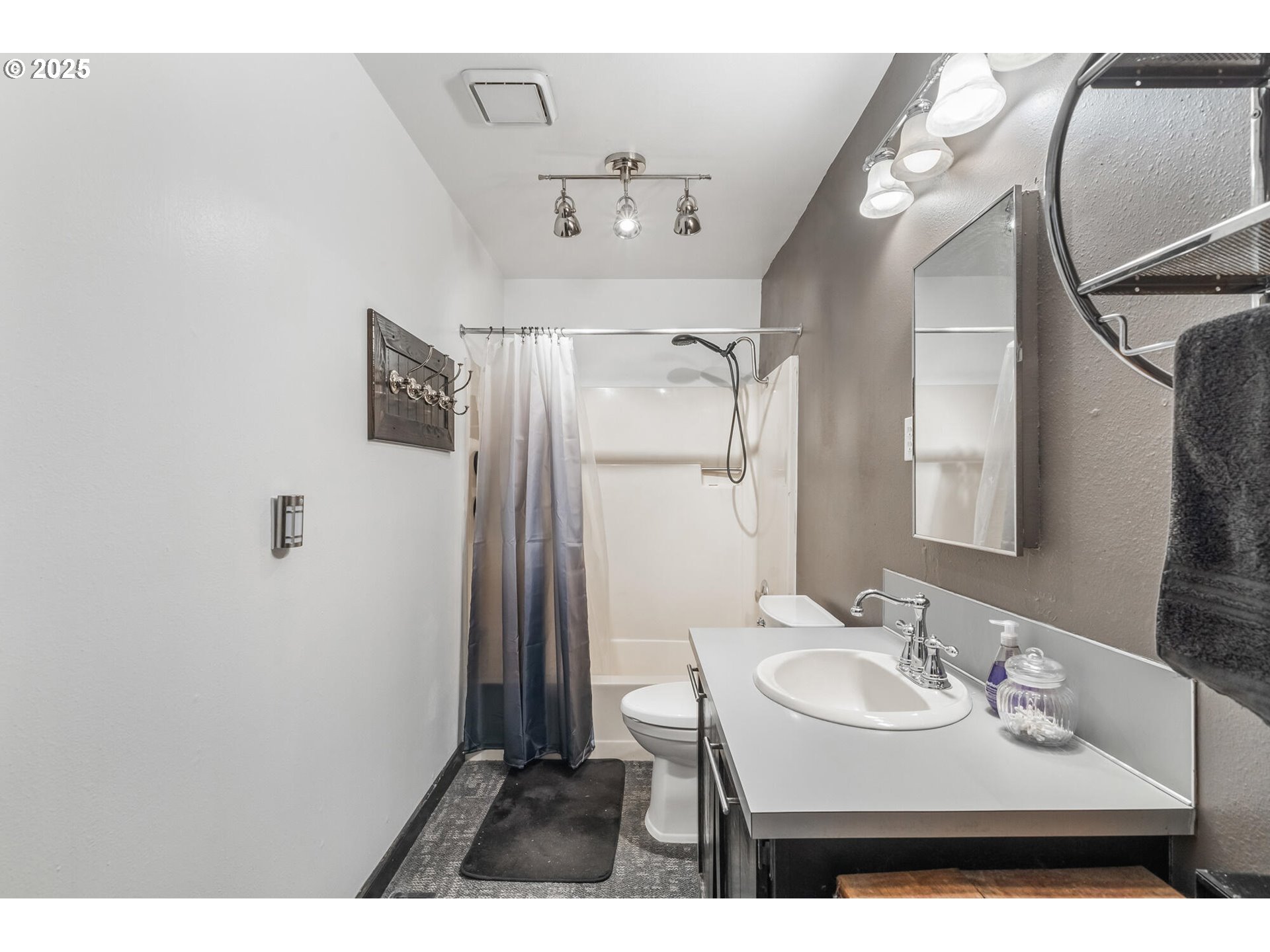 109 4th Street Garibaldi, OR 97118 - Photo 19 of 48 a bathroom with a sink a mirror and a shower