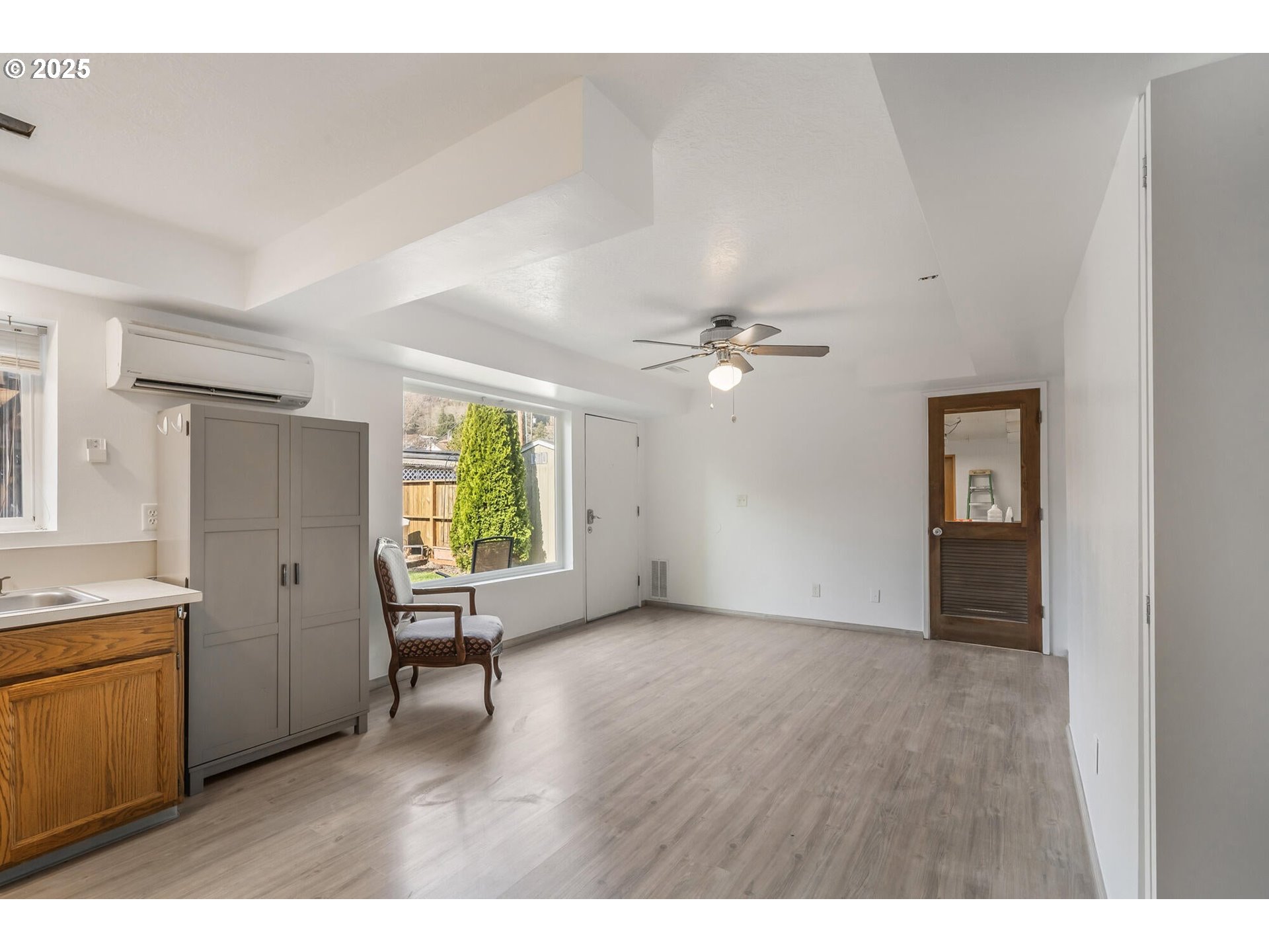 109 4th Street Garibaldi, OR 97118 - Photo 25 of 48 a view of an empty room with a window and wooden floor
