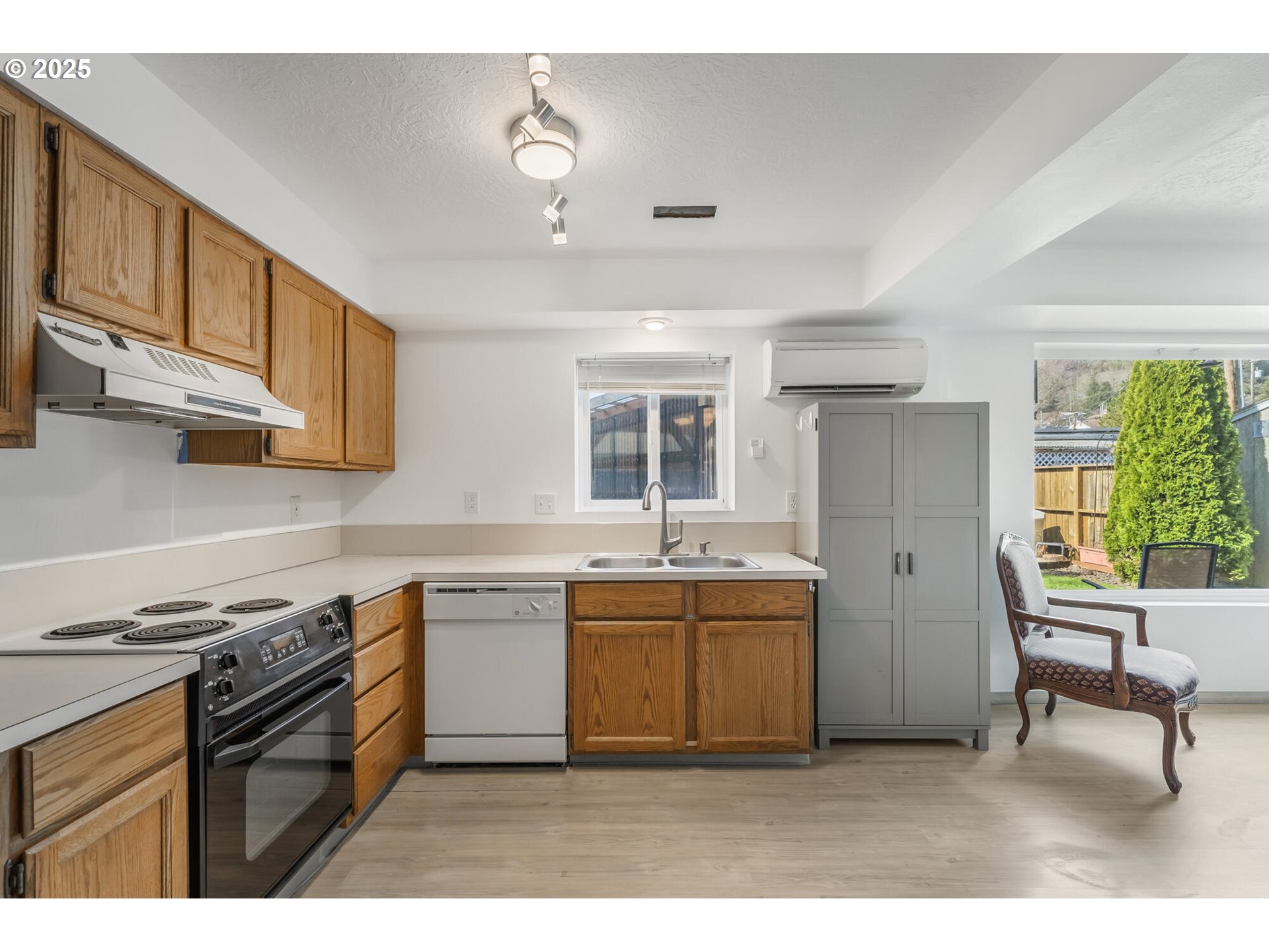 109 4th Street Garibaldi, OR 97118 - Photo 27 of 48 a kitchen with stainless steel appliances granite countertop a sink stove and refrigerator