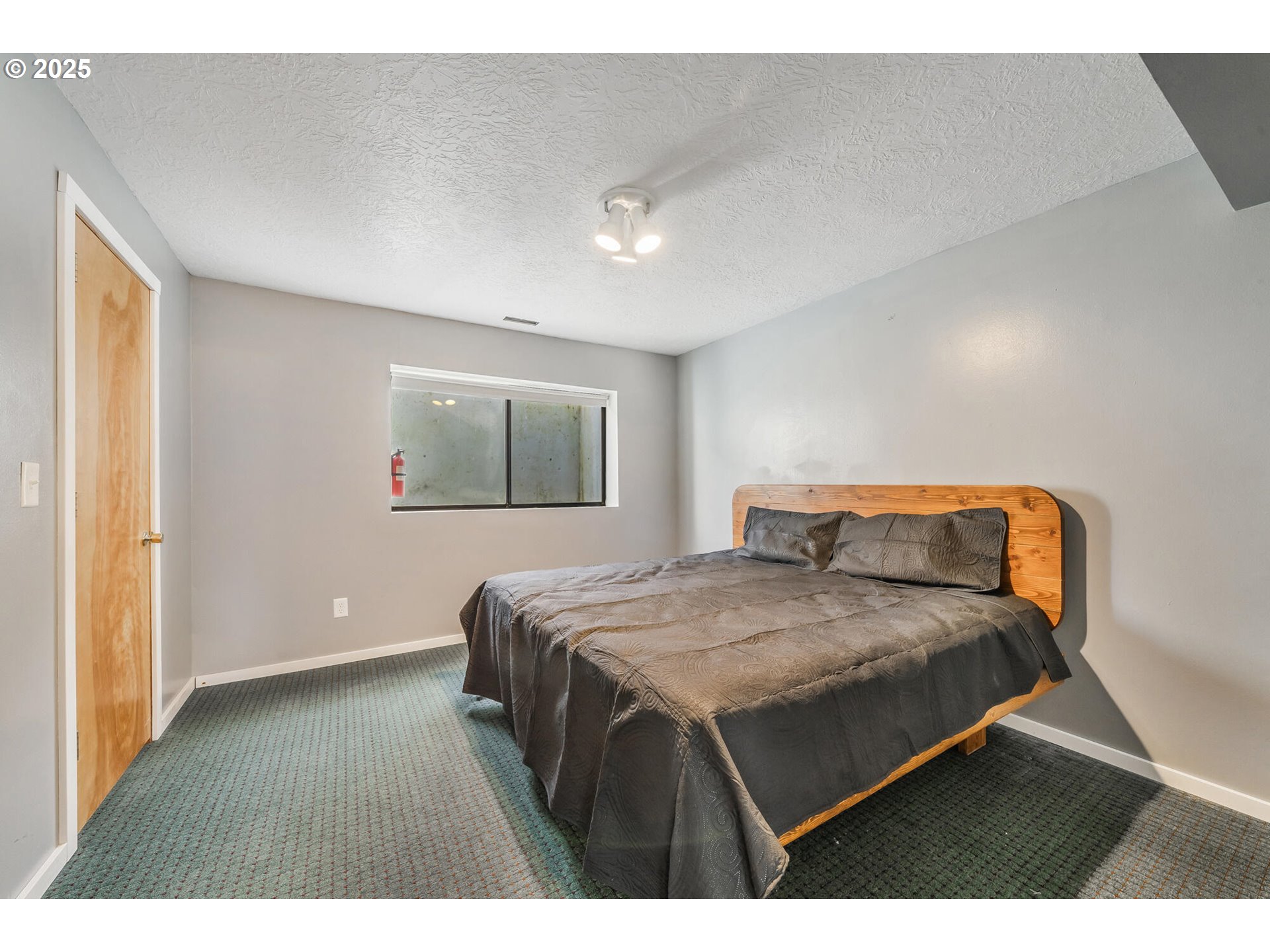109 4th Street Garibaldi, OR 97118 - Photo 28 of 48 a bedroom with a bed and a night stand