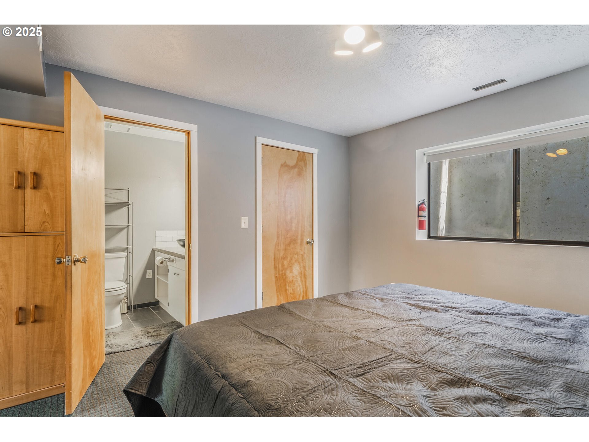 109 4th Street Garibaldi, OR 97118 - Photo 29 of 48 a bedroom with a bed and a painting