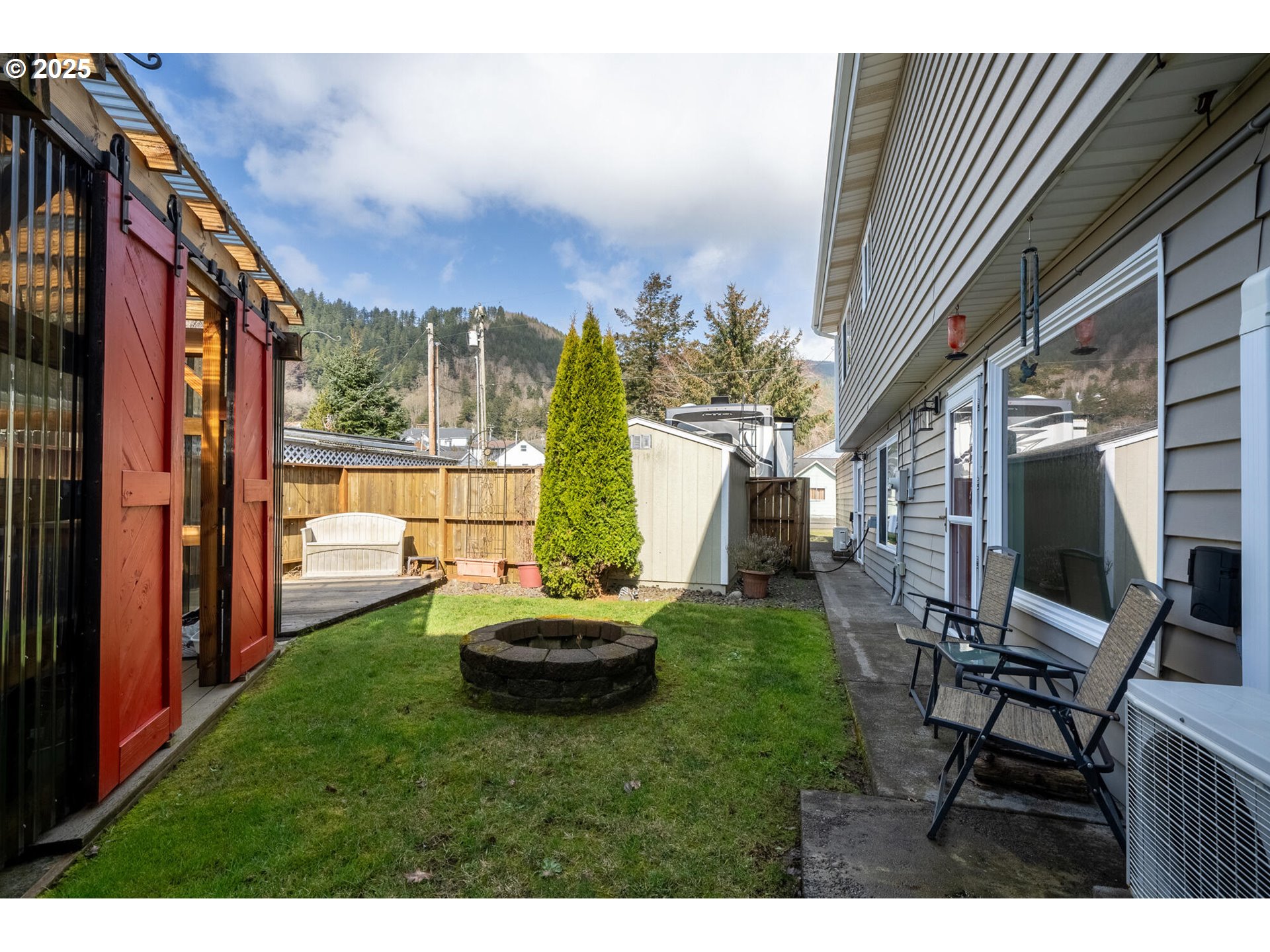 109 4th Street Garibaldi, OR 97118 - Photo 35 of 48 a backyard of a house with table and chairs