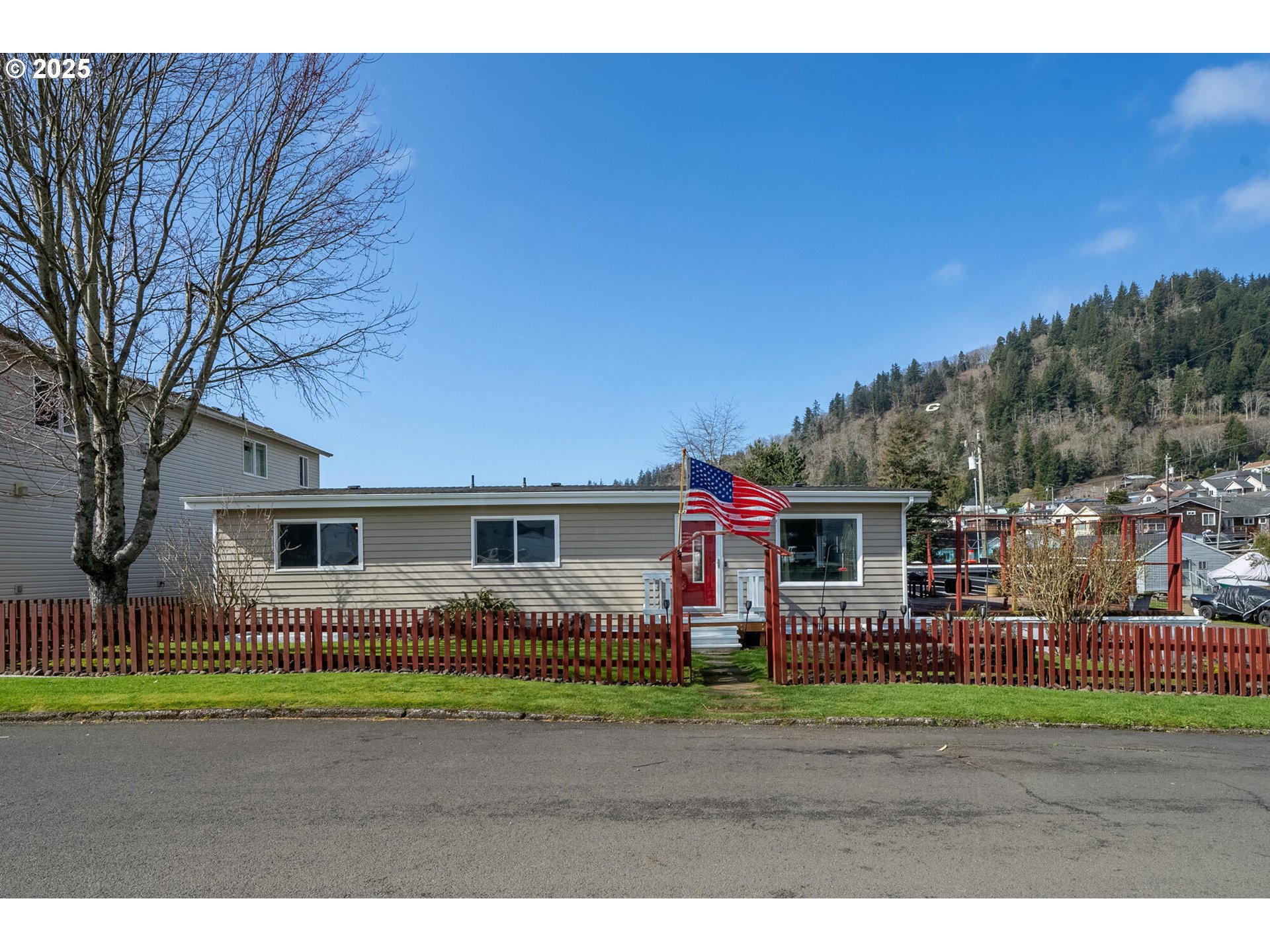109 4th Street Garibaldi, OR 97118 - Photo 42 of 48 a view of an house with backyard and trees