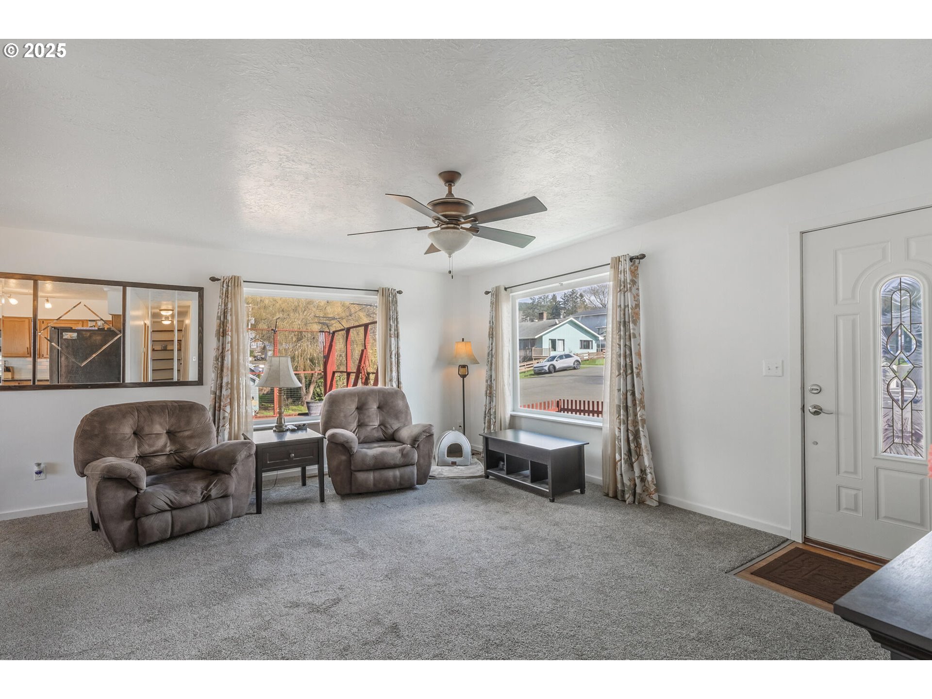 109 4th Street Garibaldi, OR 97118 - Photo 7 of 48 a living room with furniture ceiling fan and a window