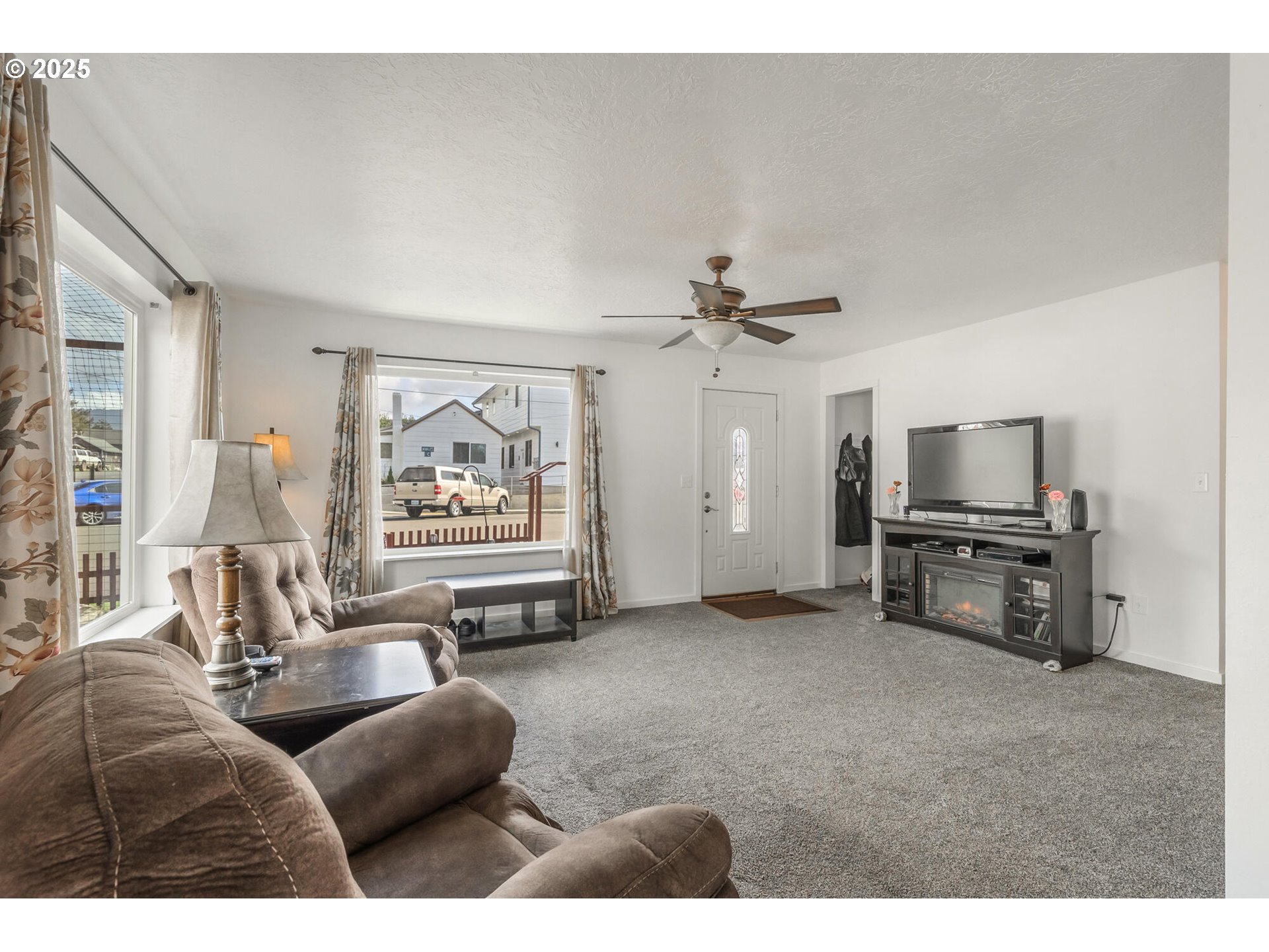 109 4th Street Garibaldi, OR 97118 - Photo 8 of 48 a living room with furniture and a flat screen tv