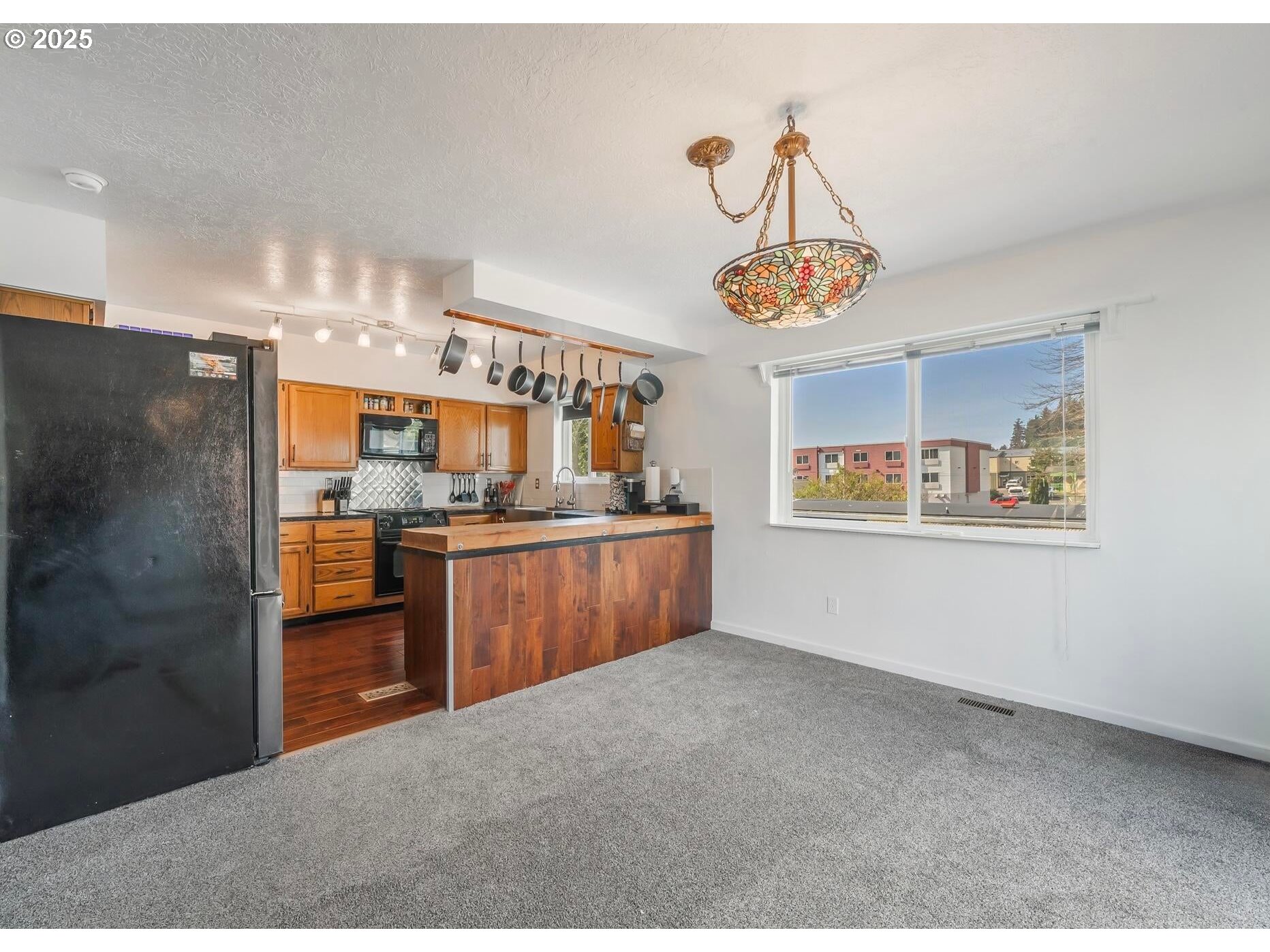 109 4th Street Garibaldi, OR 97118 - Photo 9 of 48 a kitchen with refrigerator and window
