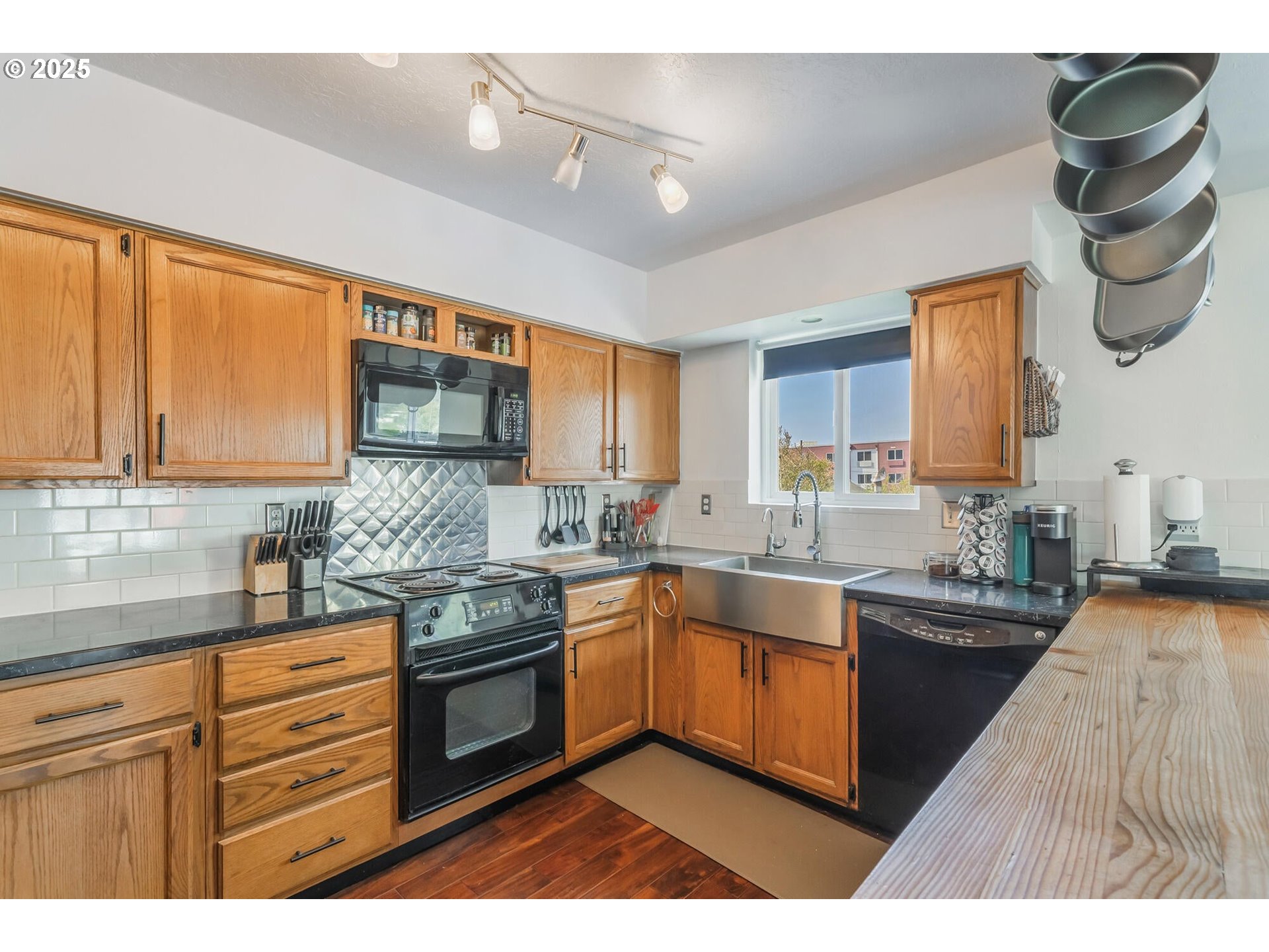 109 4th Street Garibaldi, OR 97118 - Photo 10 of 48 a kitchen with stainless steel appliances granite countertop a sink and cabinets