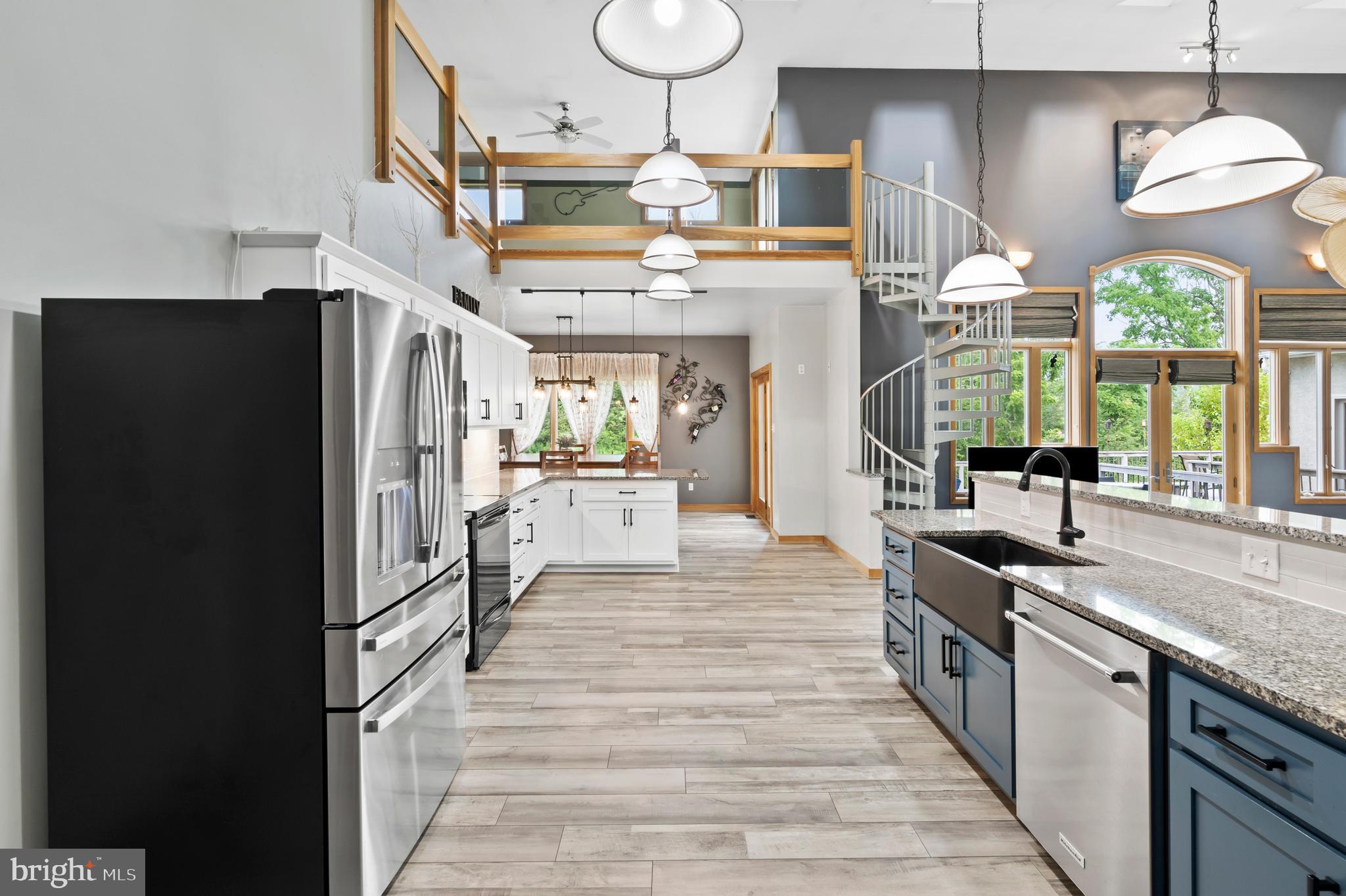 213 Cross Road Gilbertsville, PA 19525 - Photo 14 of 75 a kitchen with stainless steel appliances granite countertop a refrigerator a sink dishwasher a stove and a dining table with wooden floor