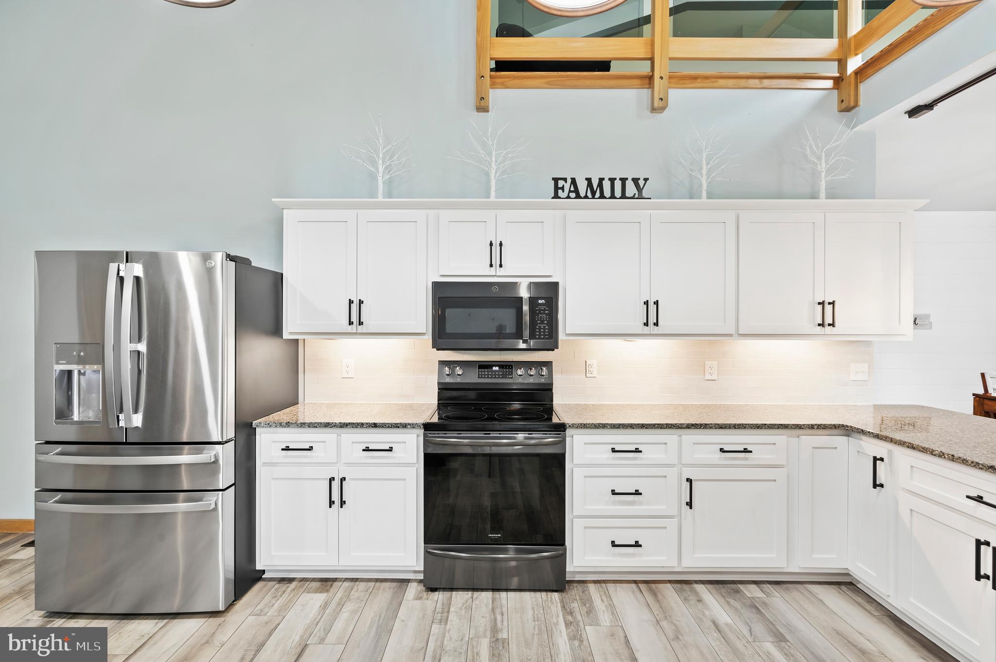 213 Cross Road Gilbertsville, PA 19525 - Photo 16 of 75 a kitchen with cabinets stainless steel appliances and wooden floor