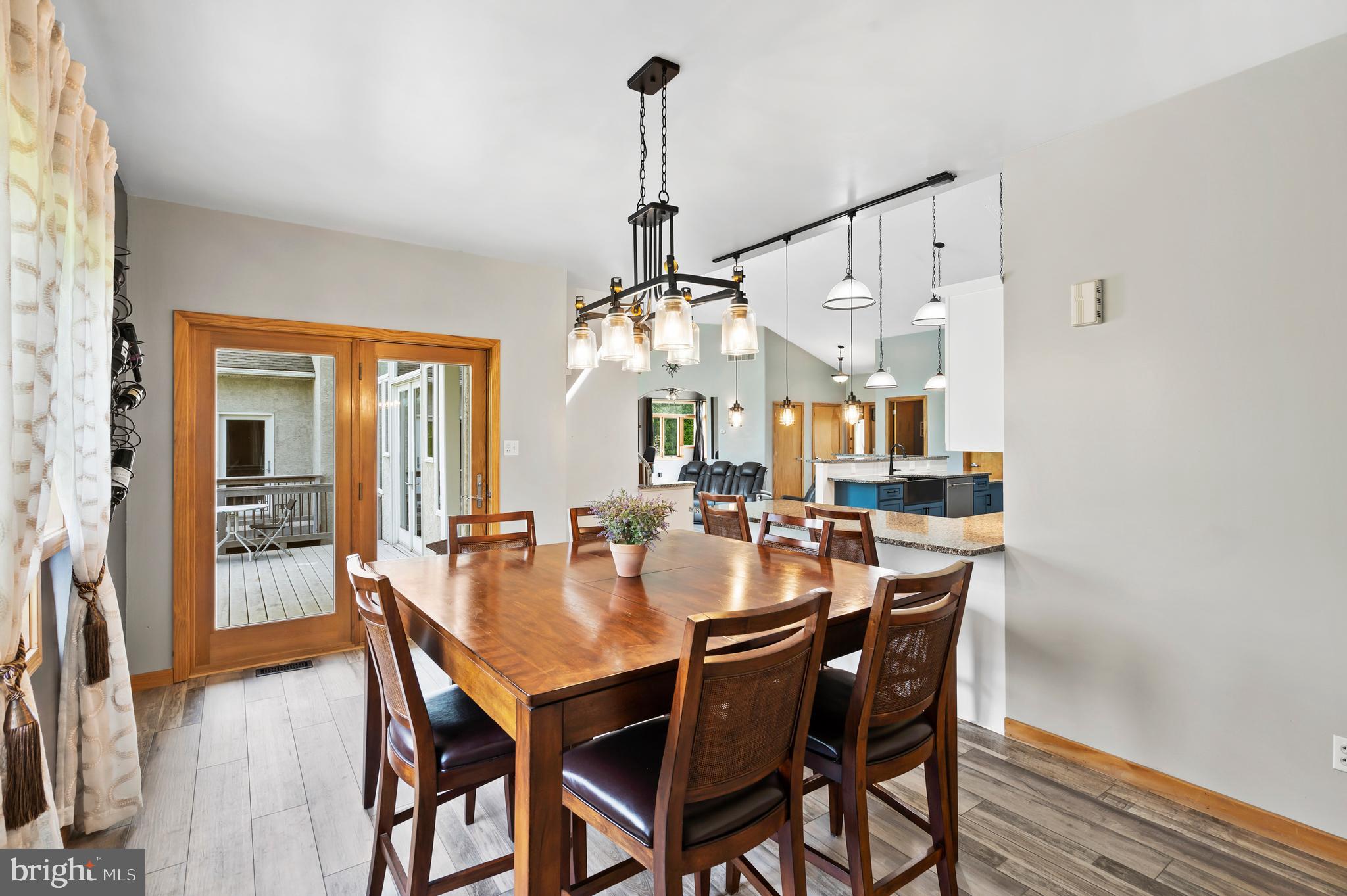 213 Cross Road Gilbertsville, PA 19525 - Photo 20 of 75 a view of a dining room and livingroom with furniture wooden floor a chandelier