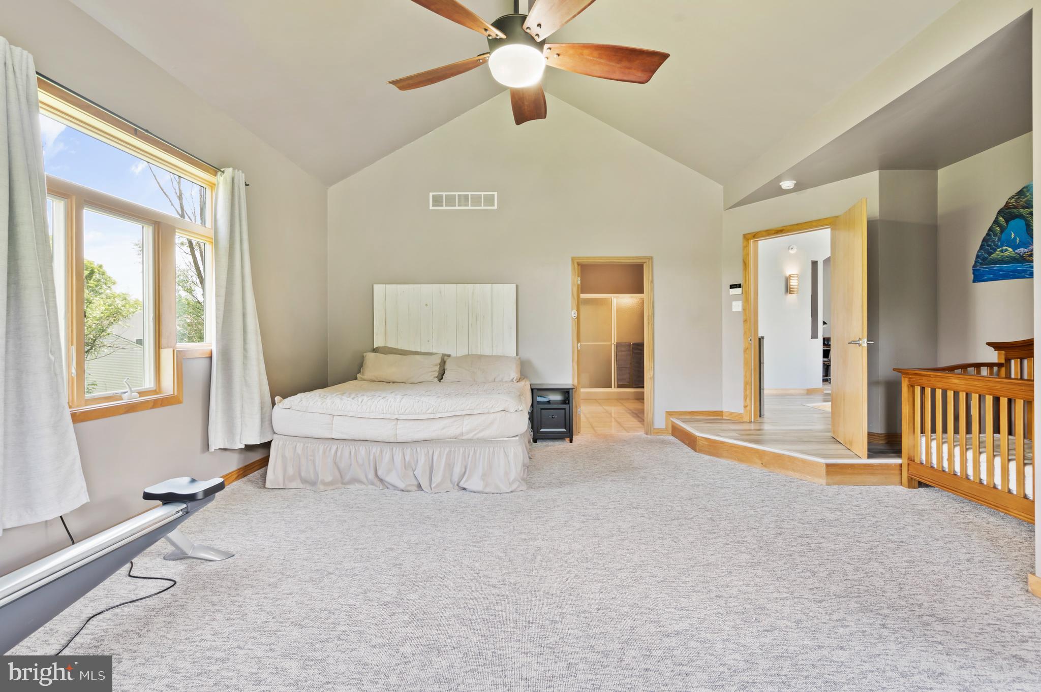 213 Cross Road Gilbertsville, PA 19525 - Photo 29 of 75 a spacious bedroom with a large bed and a chandelier fan
