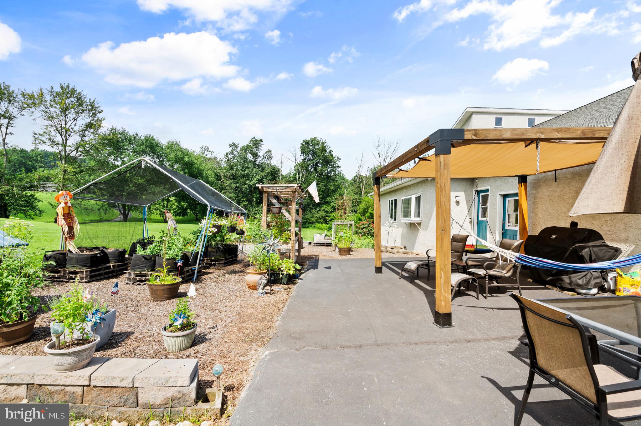 213 Cross Road Gilbertsville, PA 19525 - Photo 64 of 75 a patio with a table and chairs under an umbrella