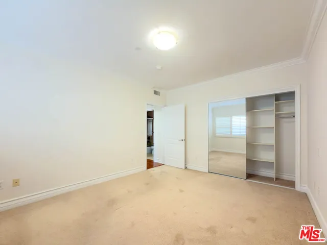 an empty room with a empty space and windows