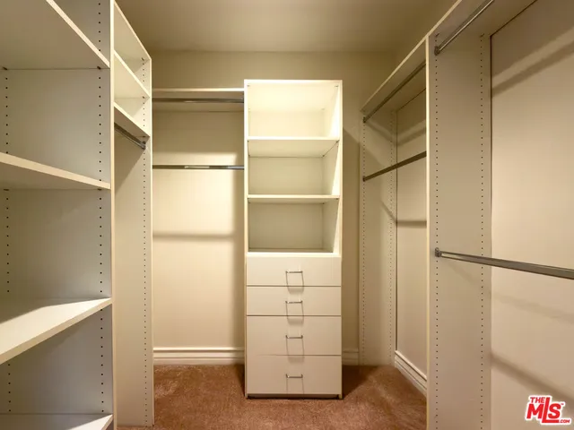 a bathroom with a tub a double vanity sink and mirror