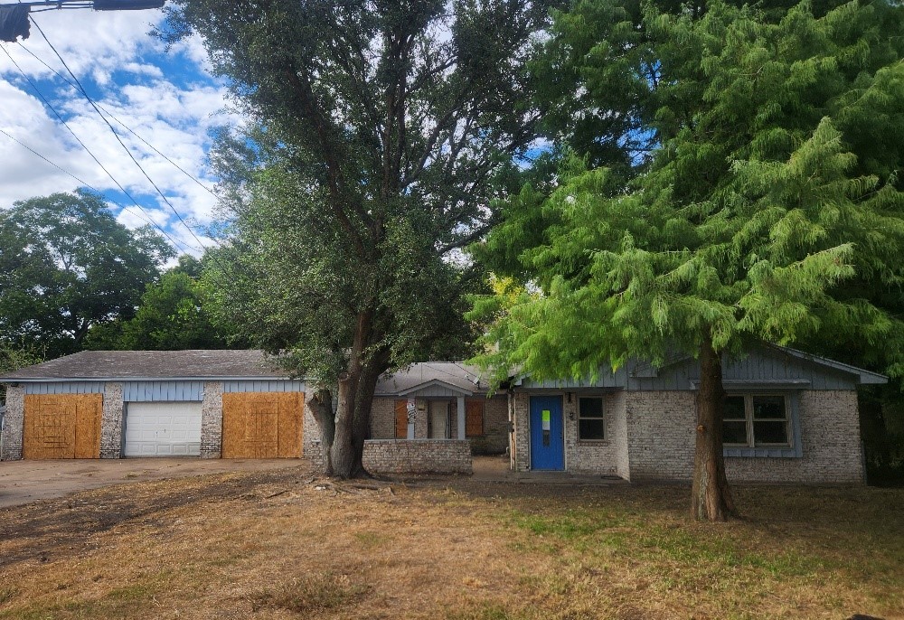 front view of a house with a tree