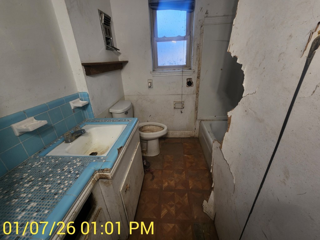 230 Kansas Street Bacliff, TX 77518 - Photo 12 of 16 a bathroom with a toilet sink and mirror