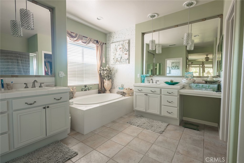 1045 Inverlochy Drive Fallbrook, CA 92028 - Photo 14 of 39 a bathroom with a granite countertop sink mirror bathtub and double