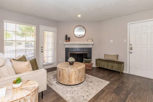 a living room with furniture and a fireplace