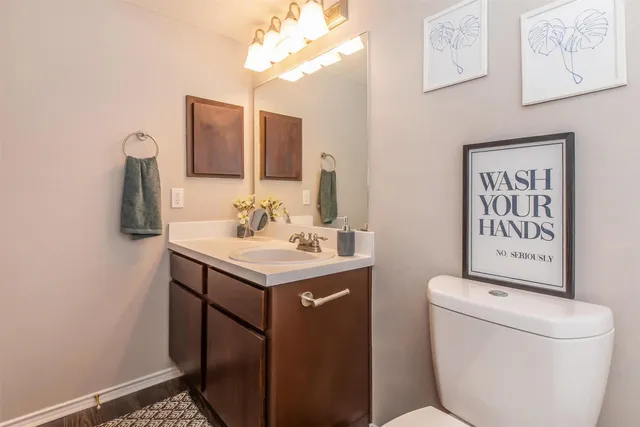 a bathroom with a toilet sink and mirror