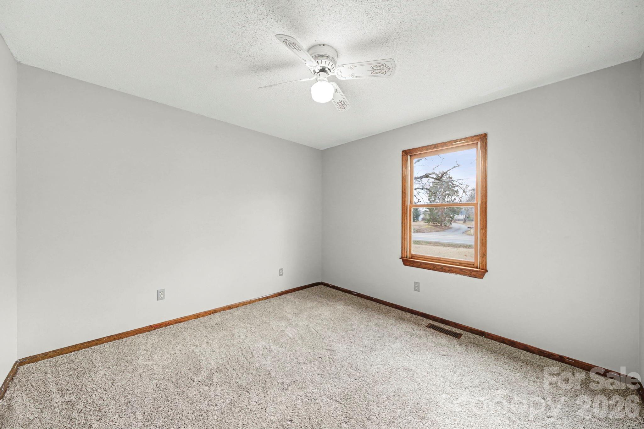 102 Roxie Lane Belmont, NC 28012 - Photo 20 of 26 an empty room with windows and fan