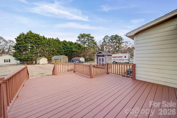 a view of balcony with wooden floor and fence